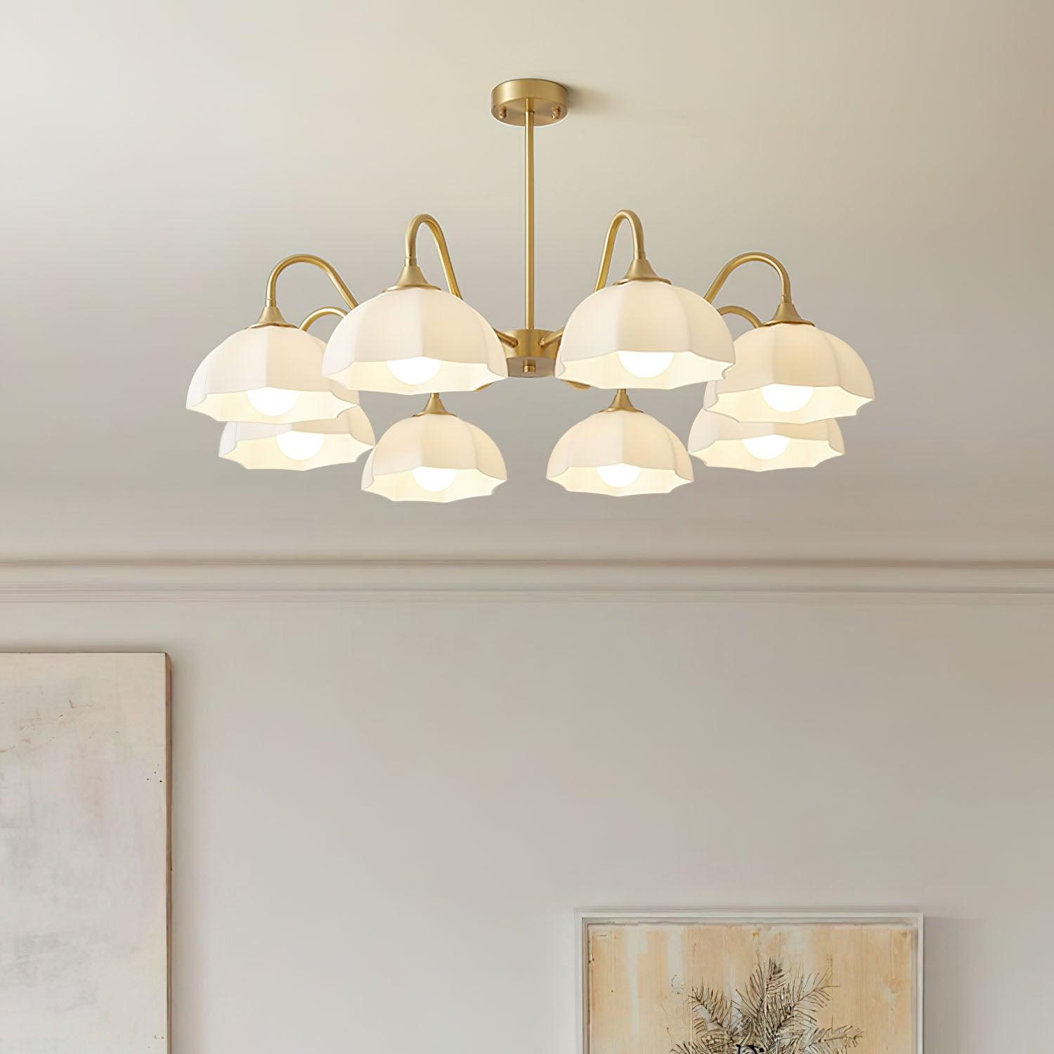 White glass chandelier above framed wall art