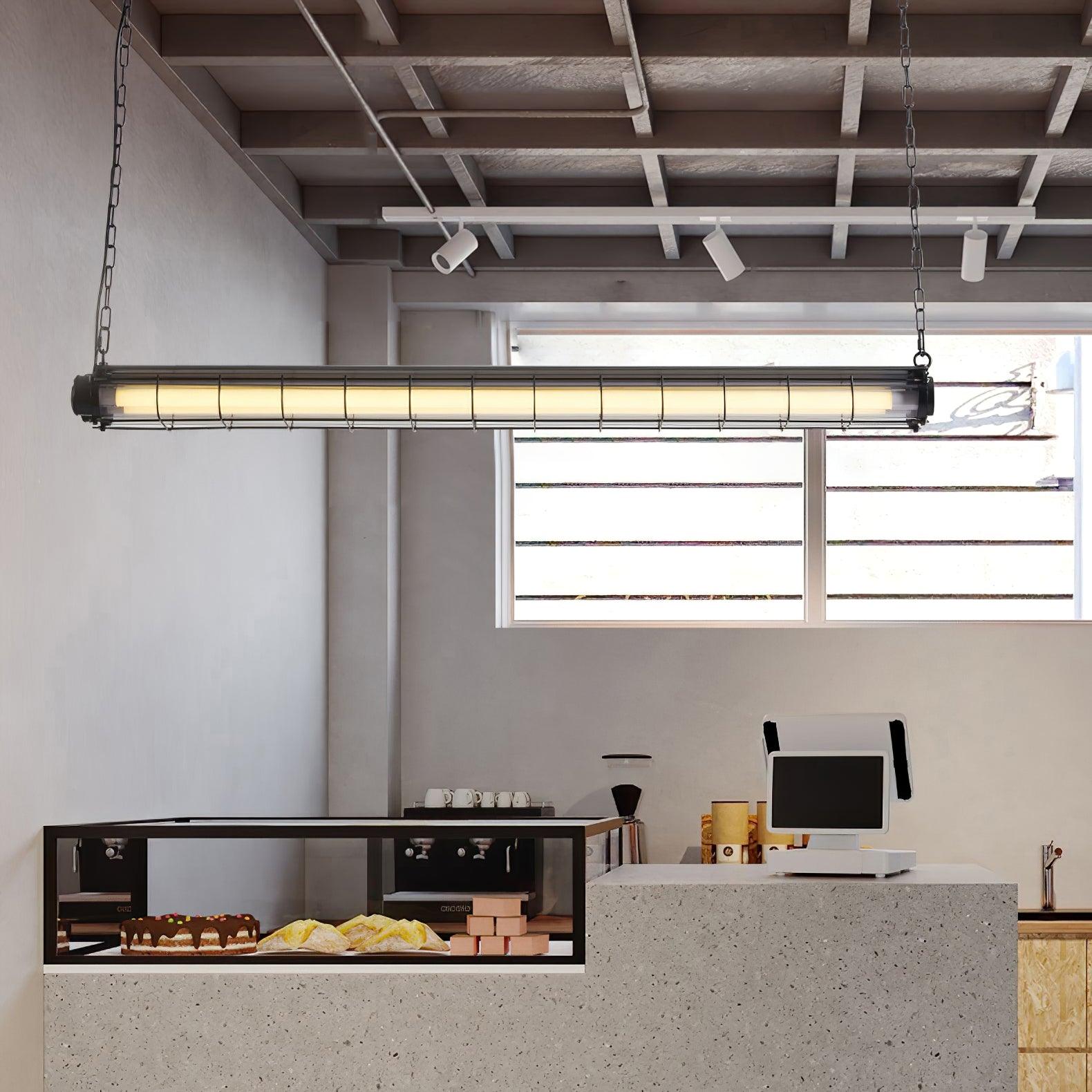 Black-ended Artisan Glass chandelier suspended above a pale counter in a room with exposed ceiling beams