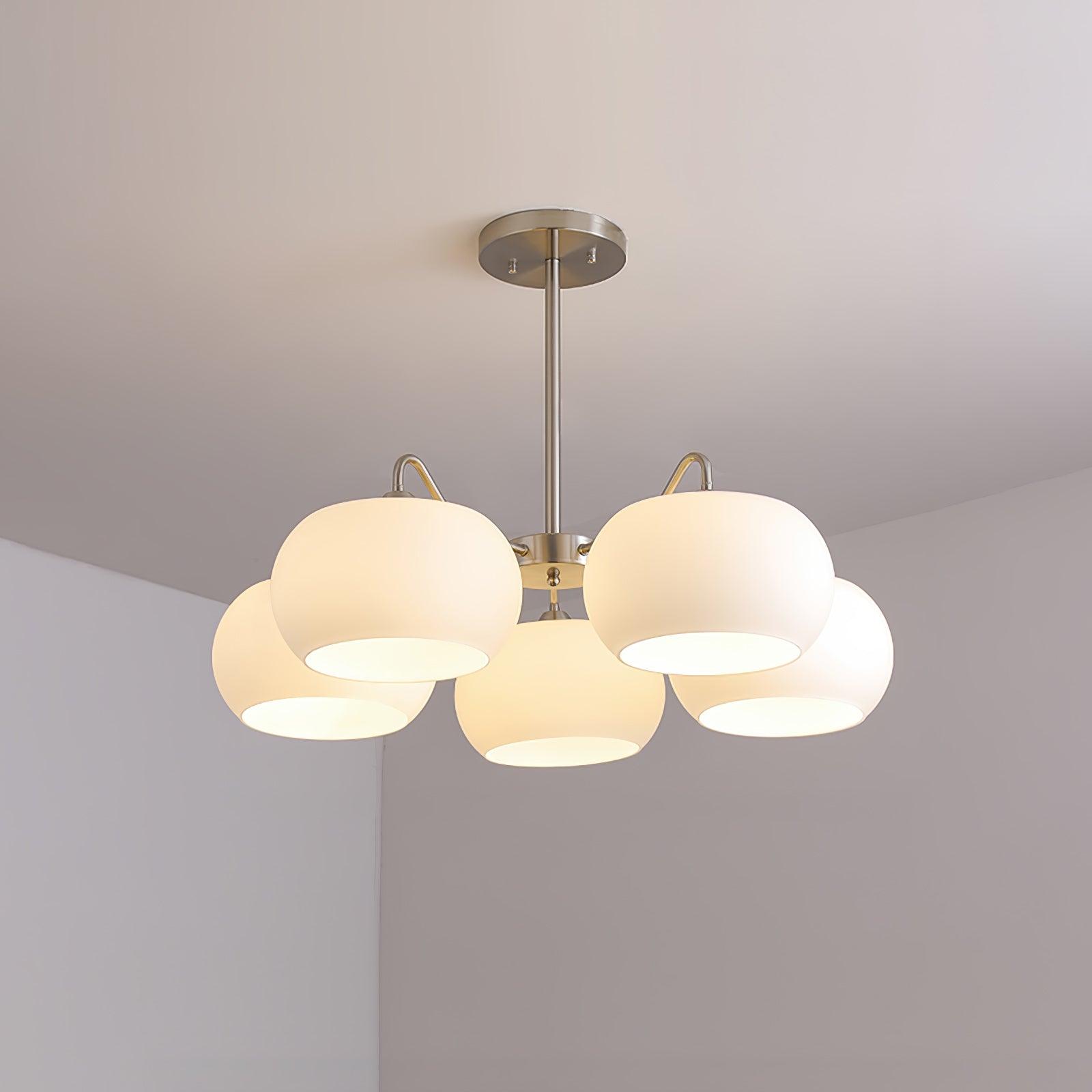 Five white open-bottom glass shades on curved nickel-tone arms with a straight rod and round canopy