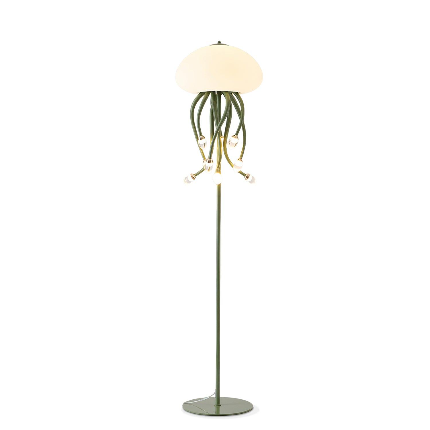 Green nine-arm Jellyfish floor lamp on white, with illuminated dome, curved hanging arms, tall stem, base and cord.