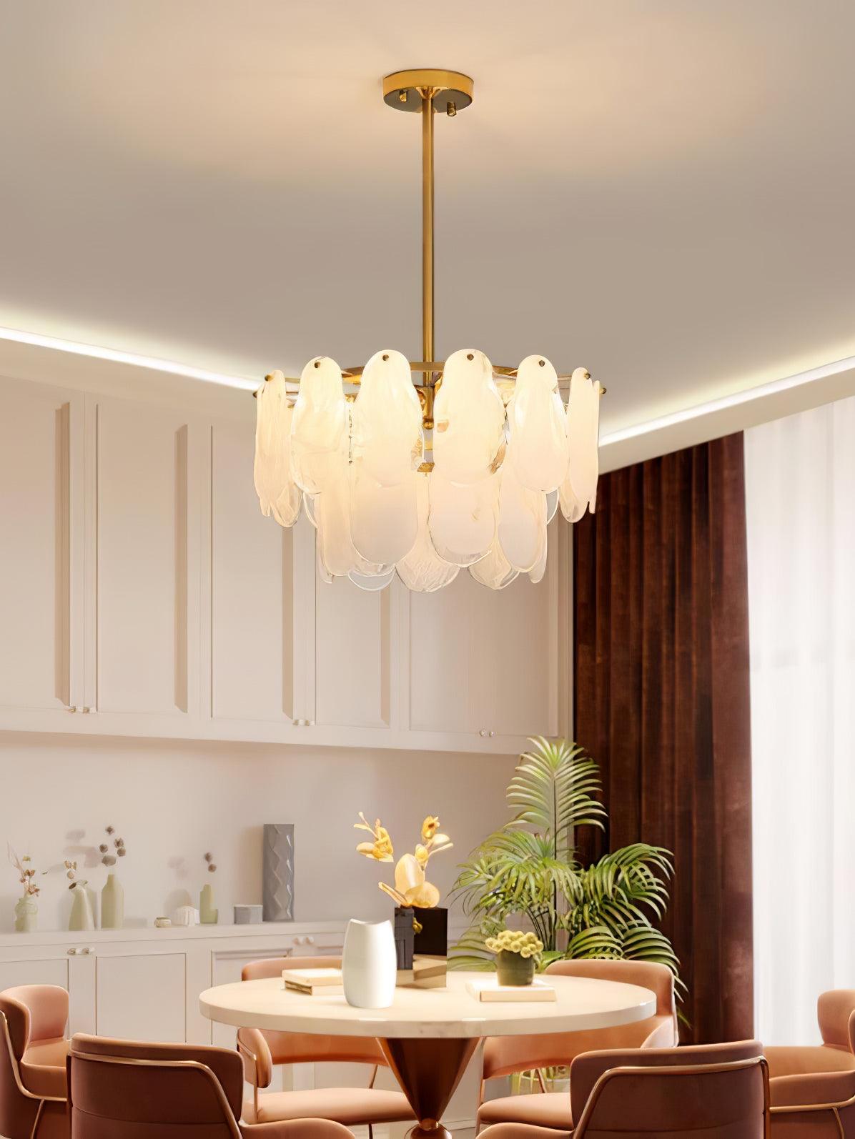 Round Cloud pendant above a wooden dining table and chairs in a room with ceiling trim