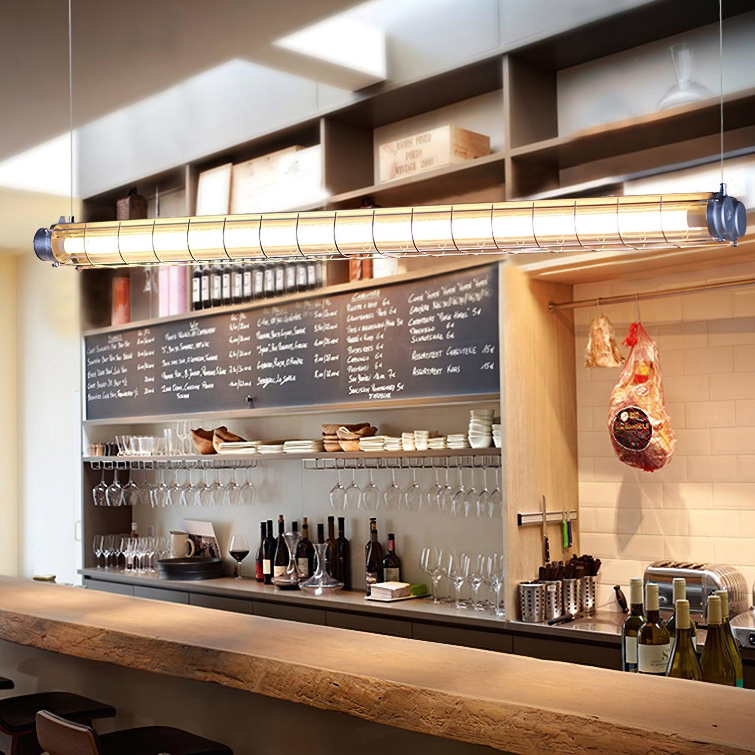 Artisan Glass linear chandelier above a cafe bar with a menu board and bottle shelves