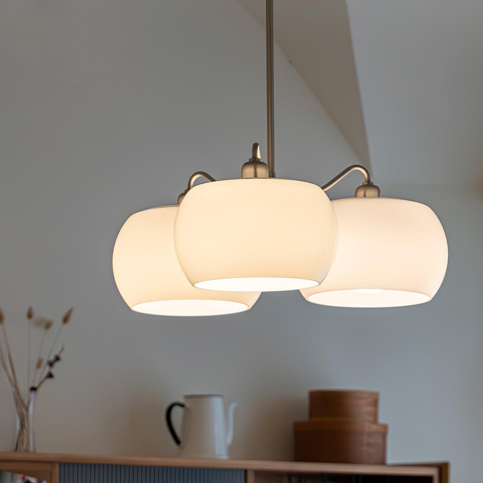 Persimmon chandelier with white glass shades and curved nickel-tone arms
