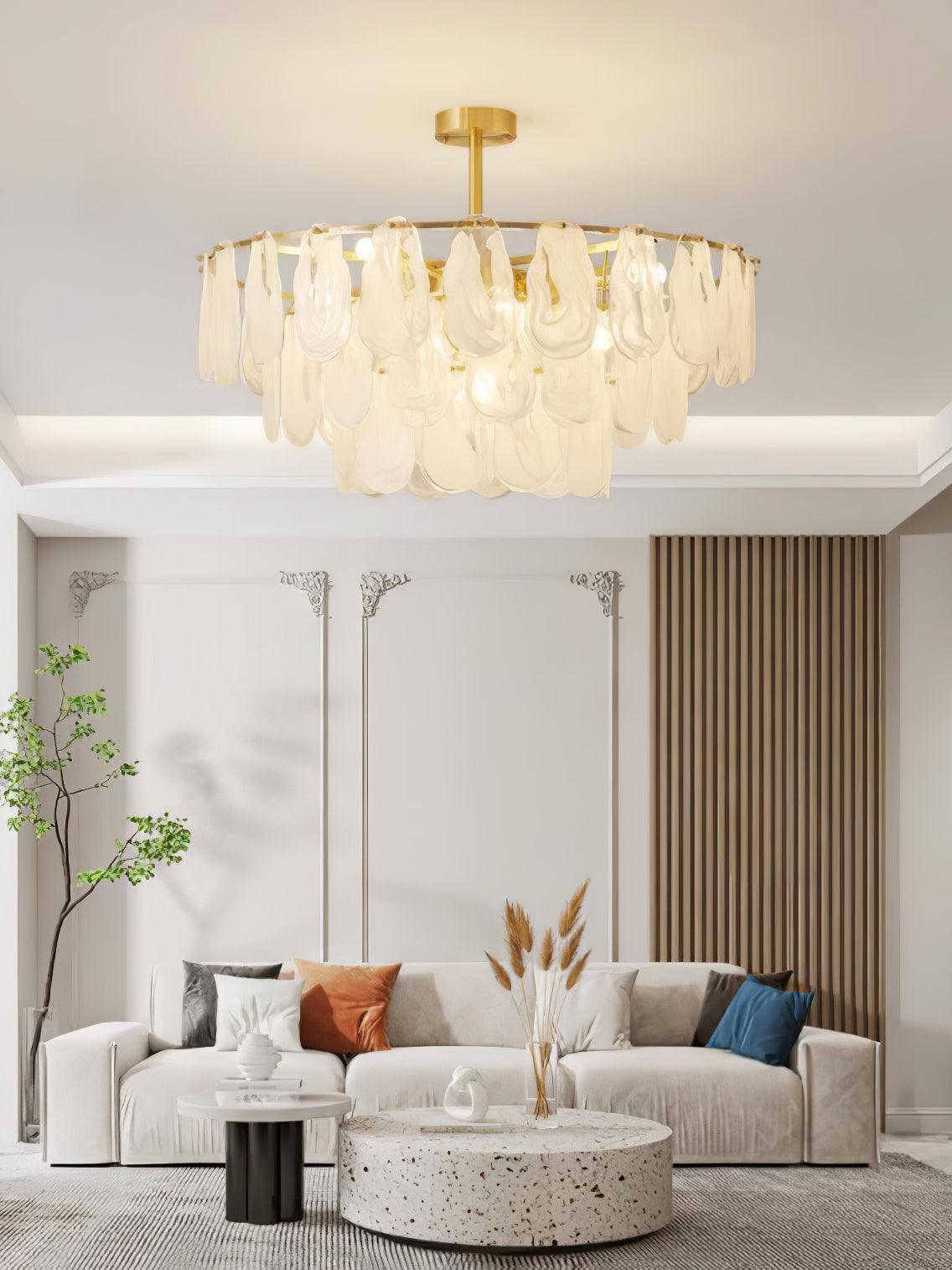 Round Cloud glass pendant above a curved sofa and circular tables in a bright living room