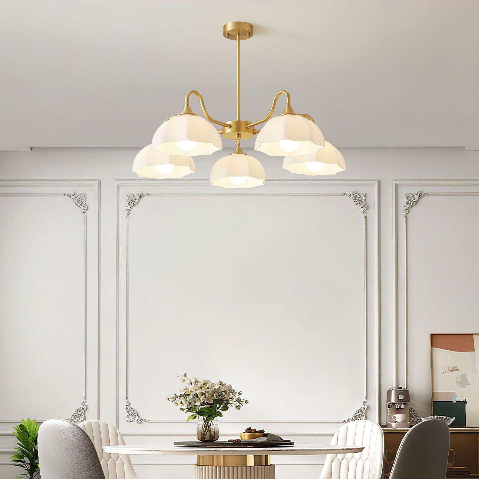 Brass glass-bowl chandelier above dining table