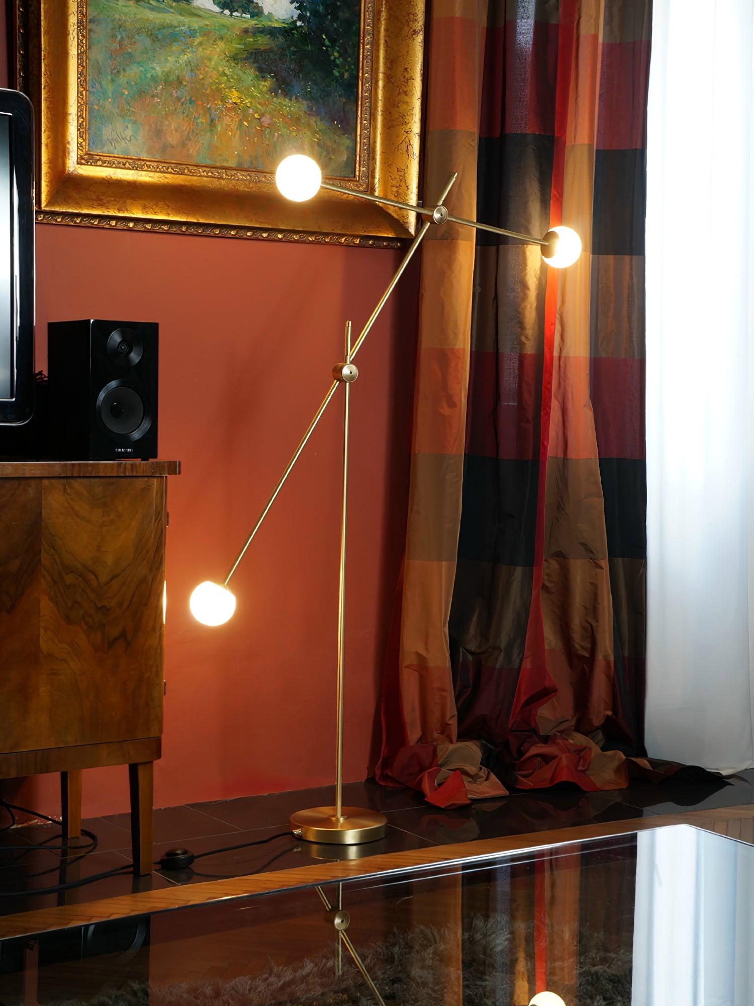 Lit Kemi floor lamp near a red wall, framed painting and patterned curtains, with a round inline switch on its cord