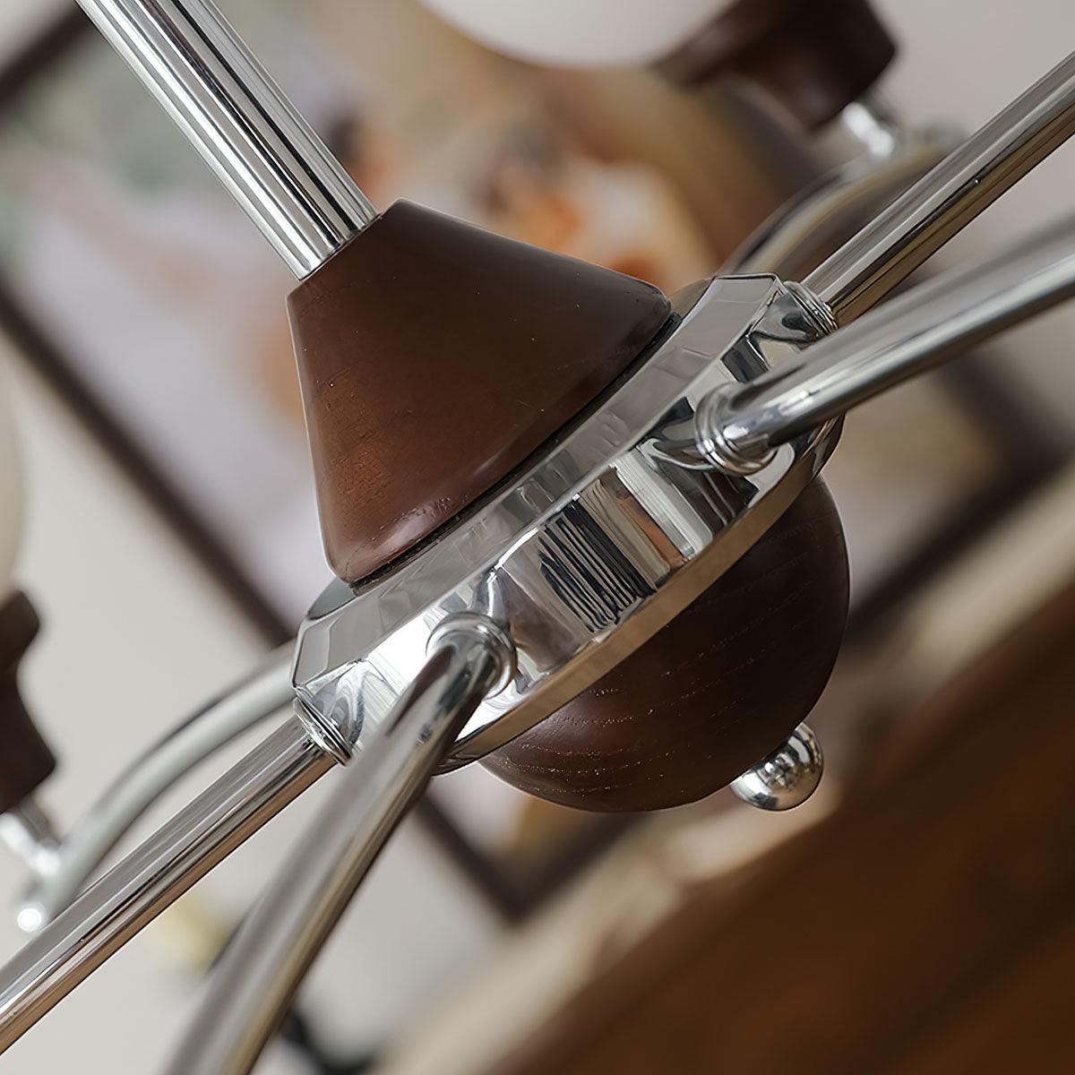 Close-up of walnut cone and lower dome around a chrome central hub with curved metal arms