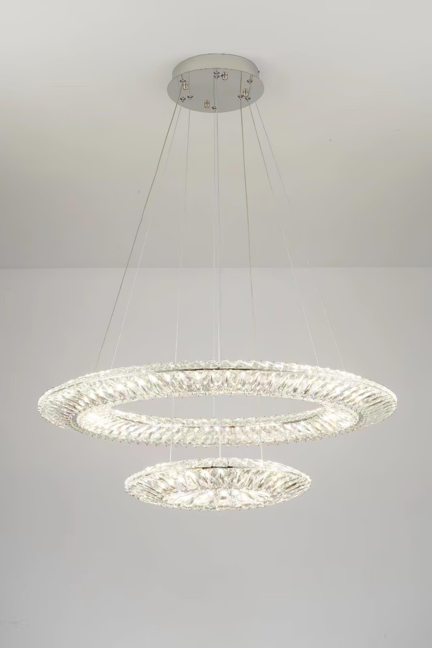 Illuminated two-tier crystal arrangement below a white ceiling
