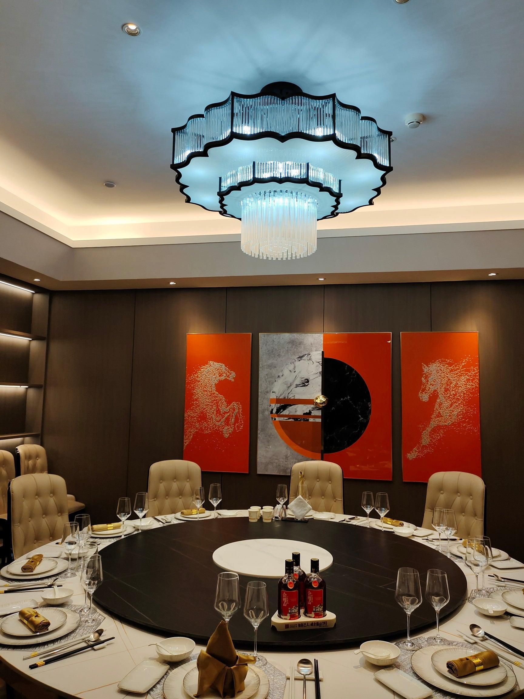 Pharo II tiered chandelier with clear ridged elements and a scalloped metal frame
