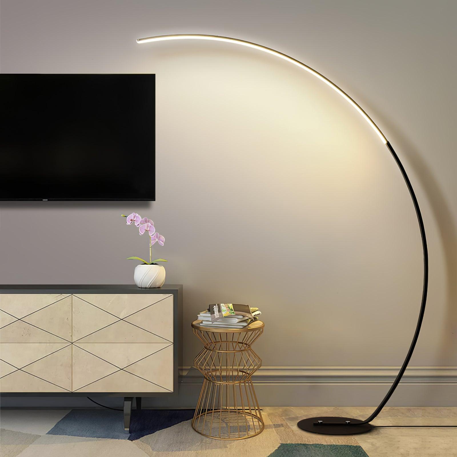 Alternate full view of Black Arc floor lamp beside television cabinet, orchid and wire side table