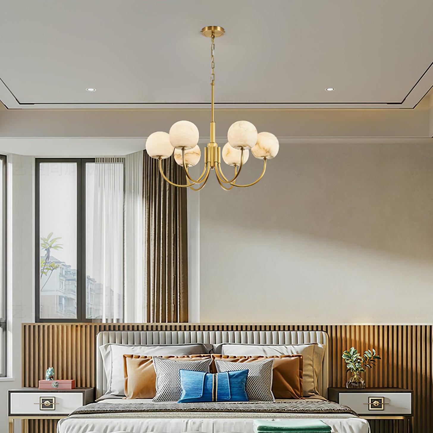 Alabaster globe chandelier centered above a bed