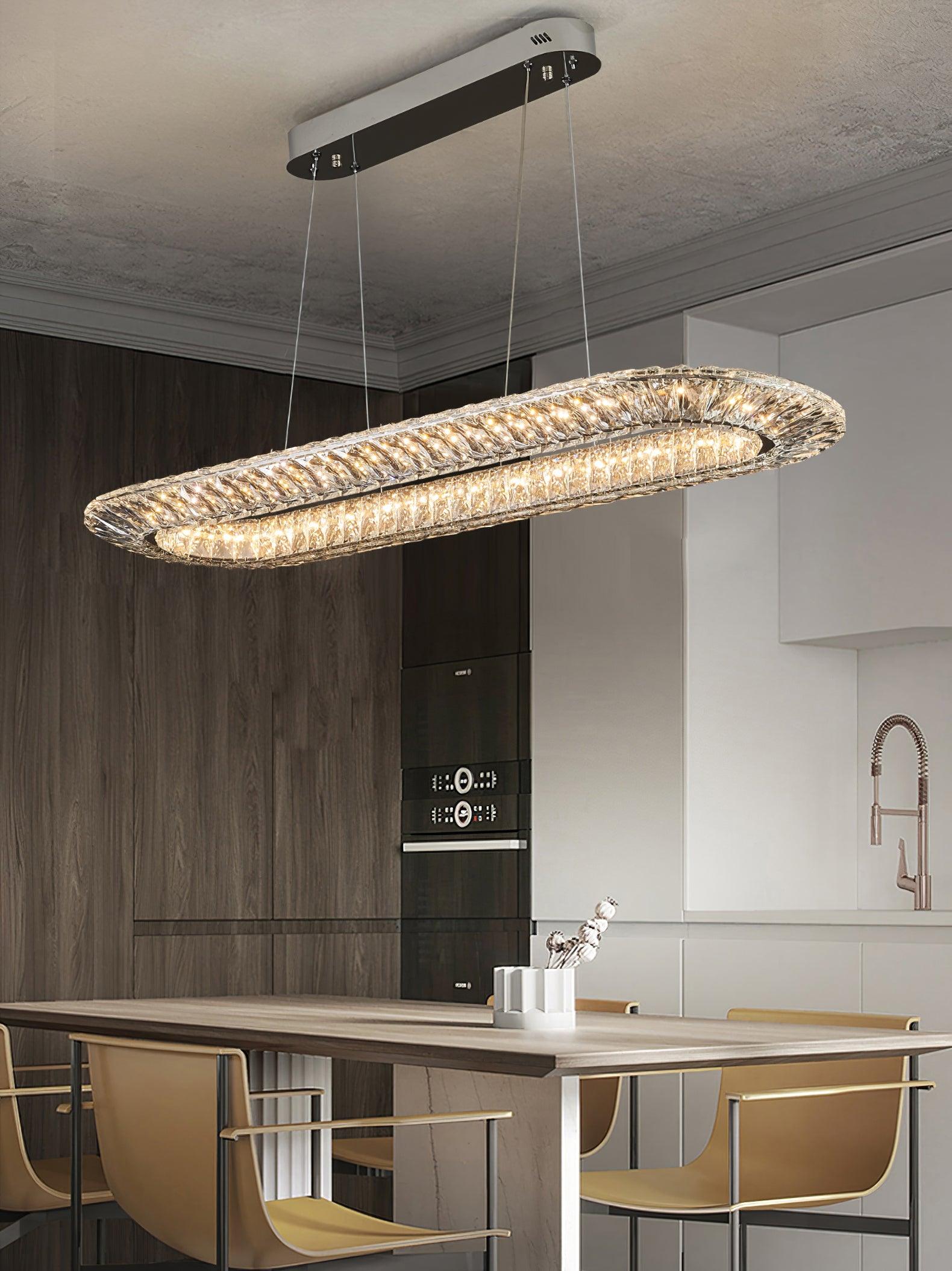 Elongated racetrack chandelier above a kitchen island