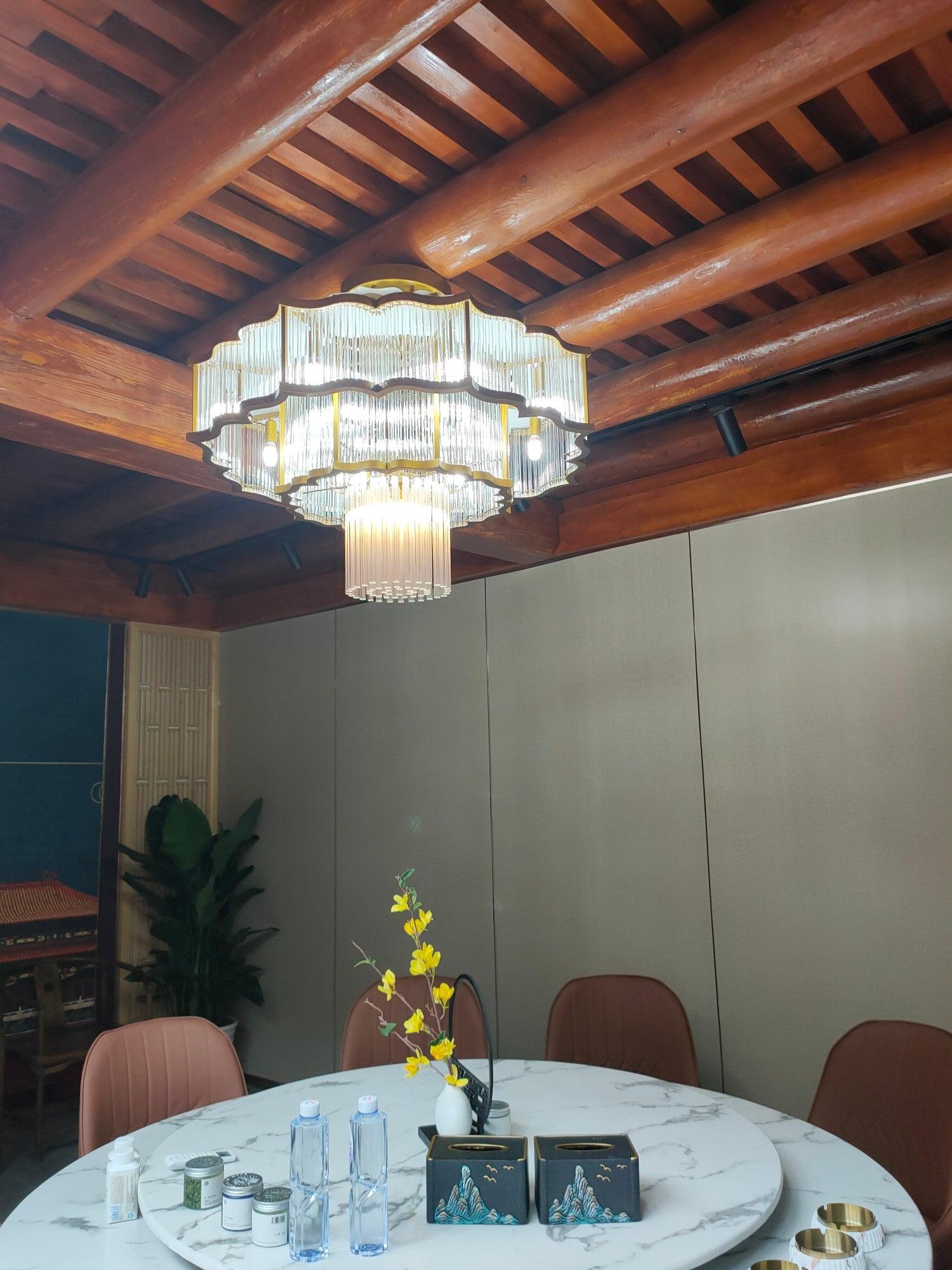 Pharo II tiered chandelier with clear ridged elements and a scalloped metal frame