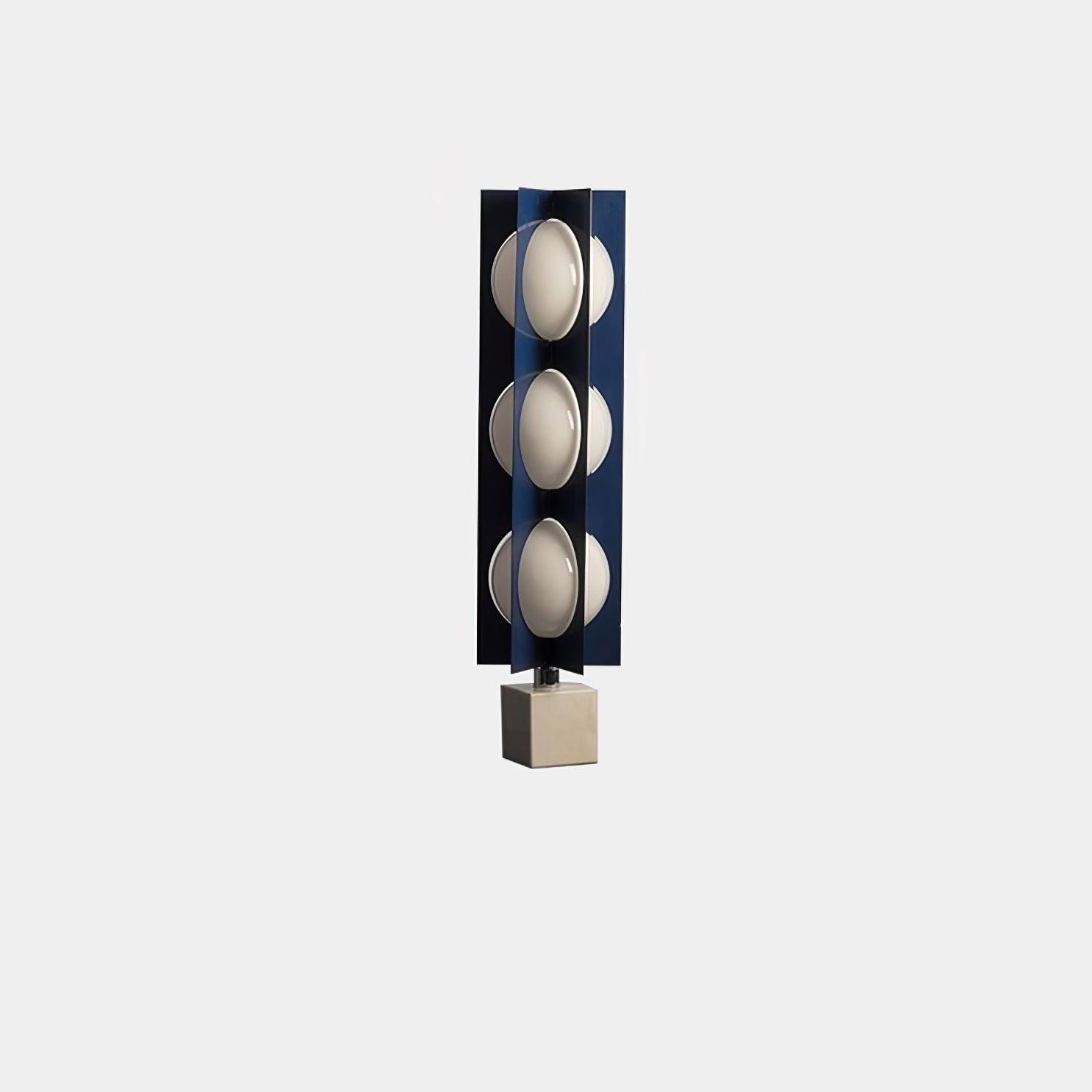 Isolated three-level blue column lamp with unlit white shades and a white block base against a pale background