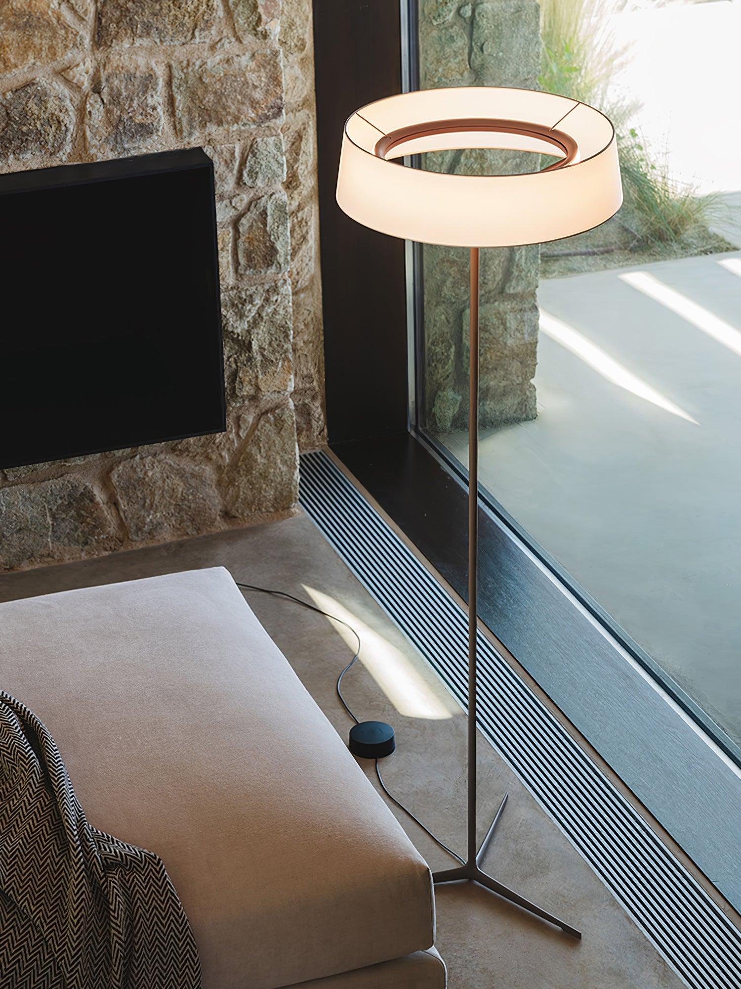 Open-centre circular shade and cord button beside a window