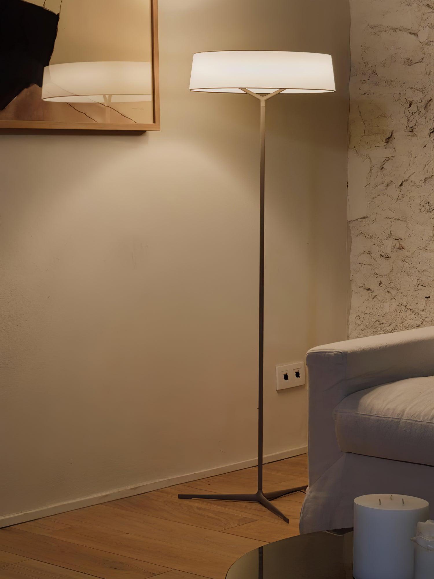 Grey Paper Glow lamp near a sofa arm
