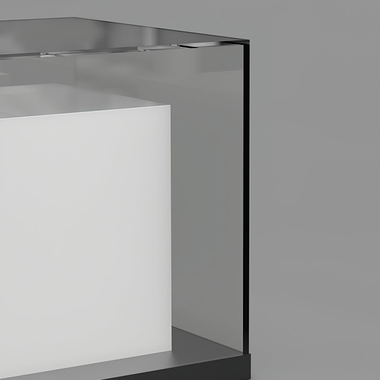 Close-up of the clear outer panel and top corner, white inner cube, narrow dark edge and base of the unlit light