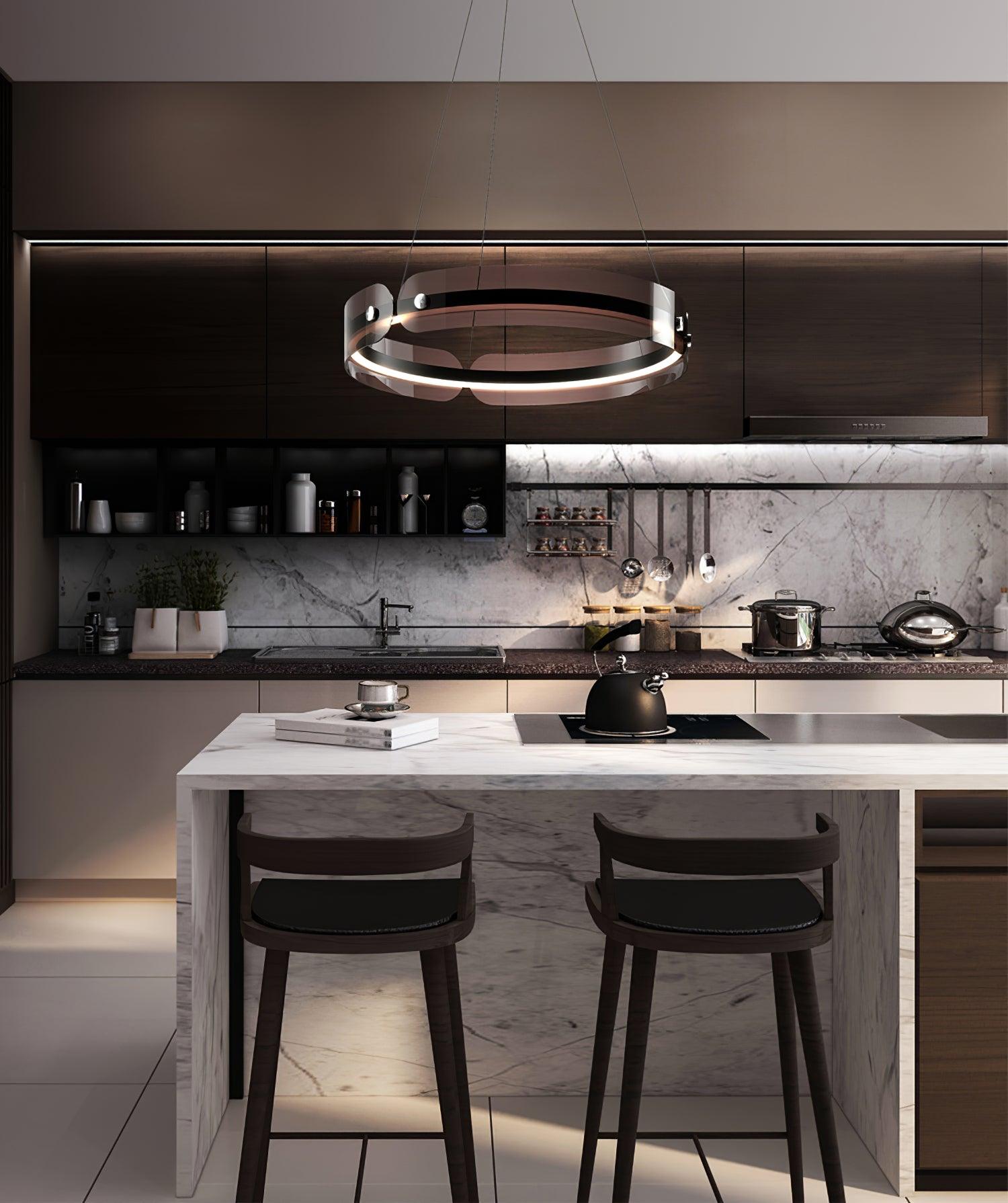 Javor black and coffee ring above a marble-look kitchen island with two dark stools and a kettle
