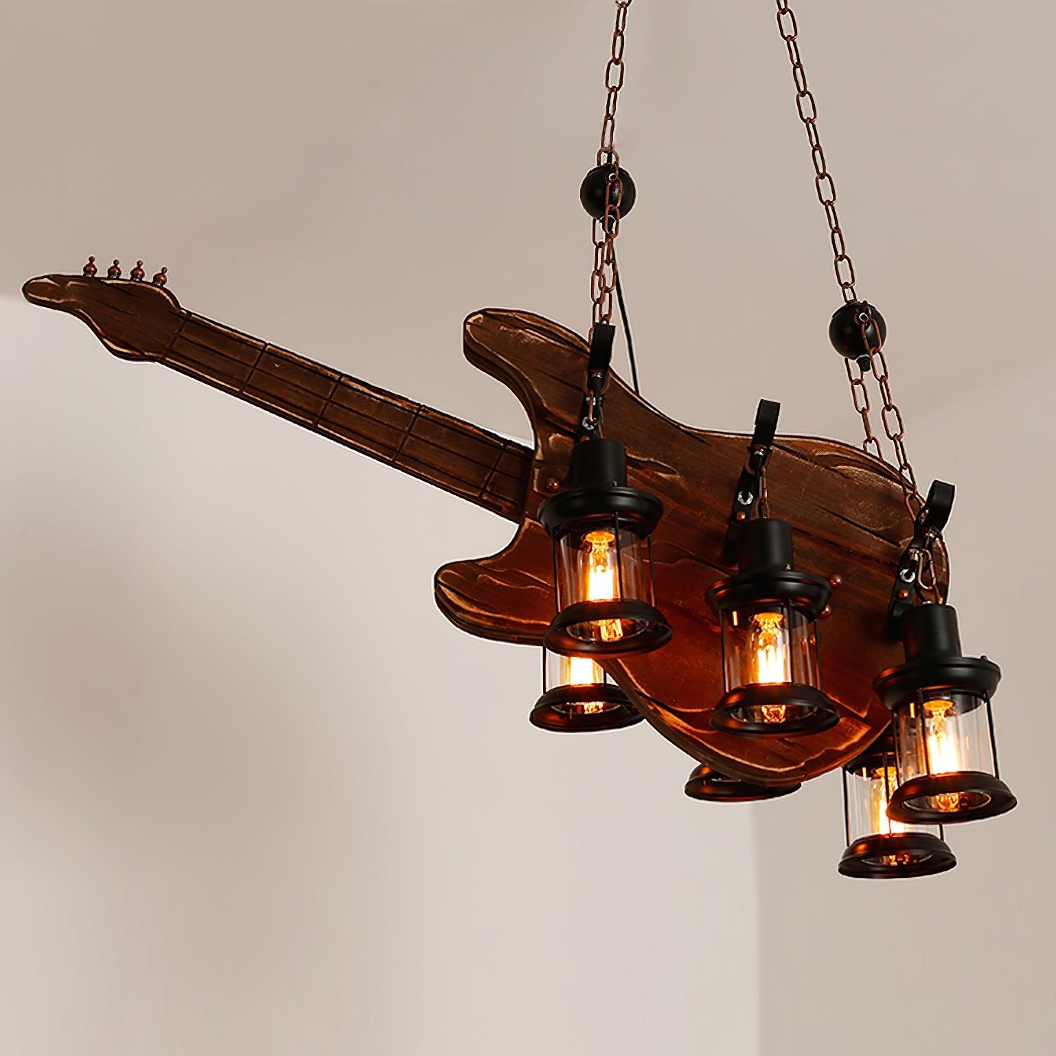Electric-style guitar fixture with suspended lanterns