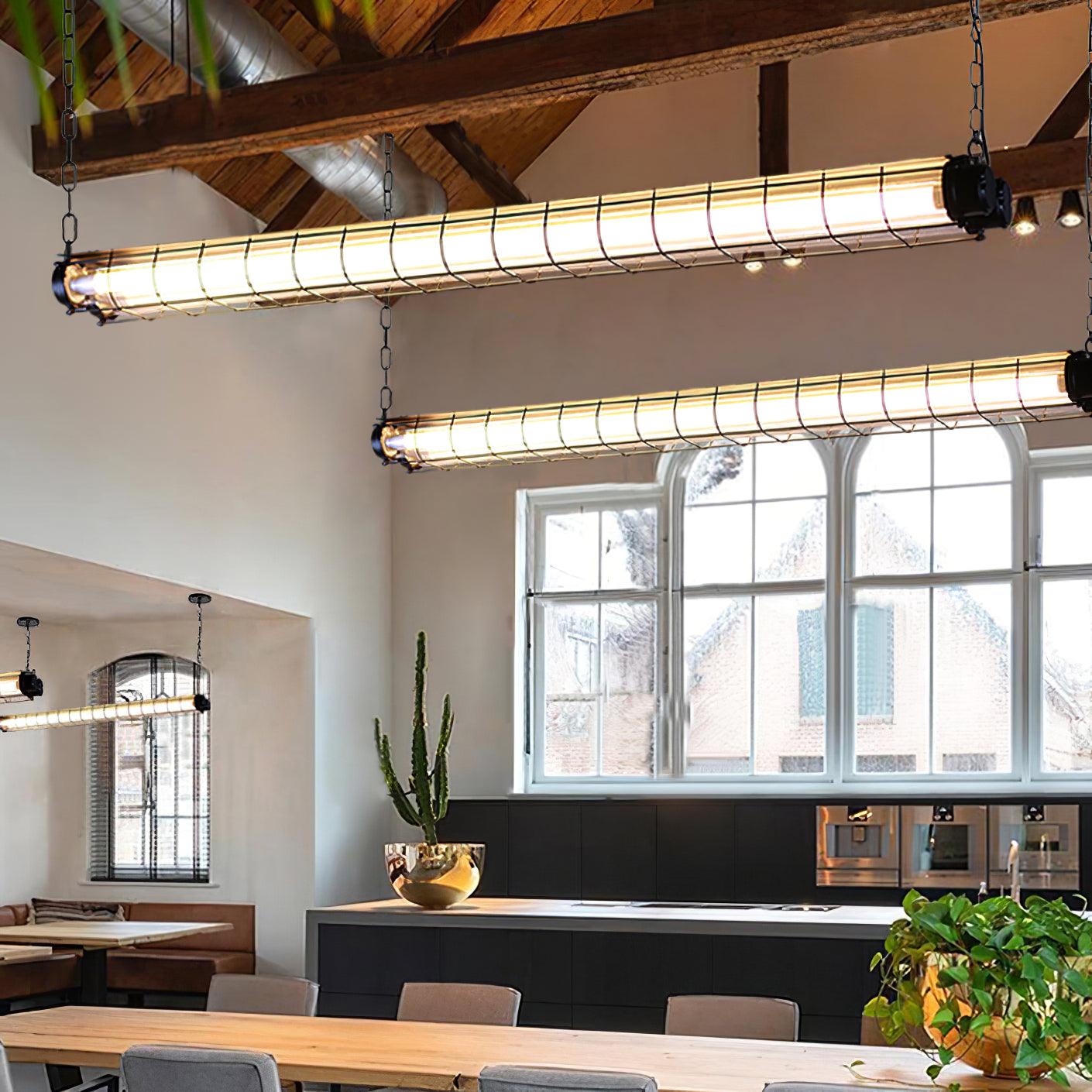 Two Artisan Glass linear chandeliers at different positions in a bright cafe with large windows