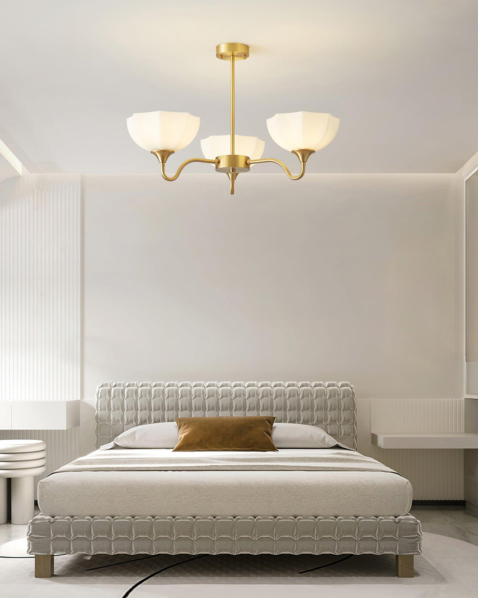 Upward-facing white bowl chandelier over a bed