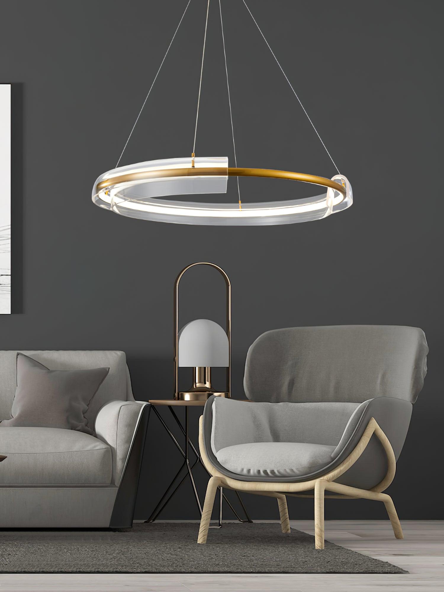 Gold-and-clear ring chandelier beside an armchair