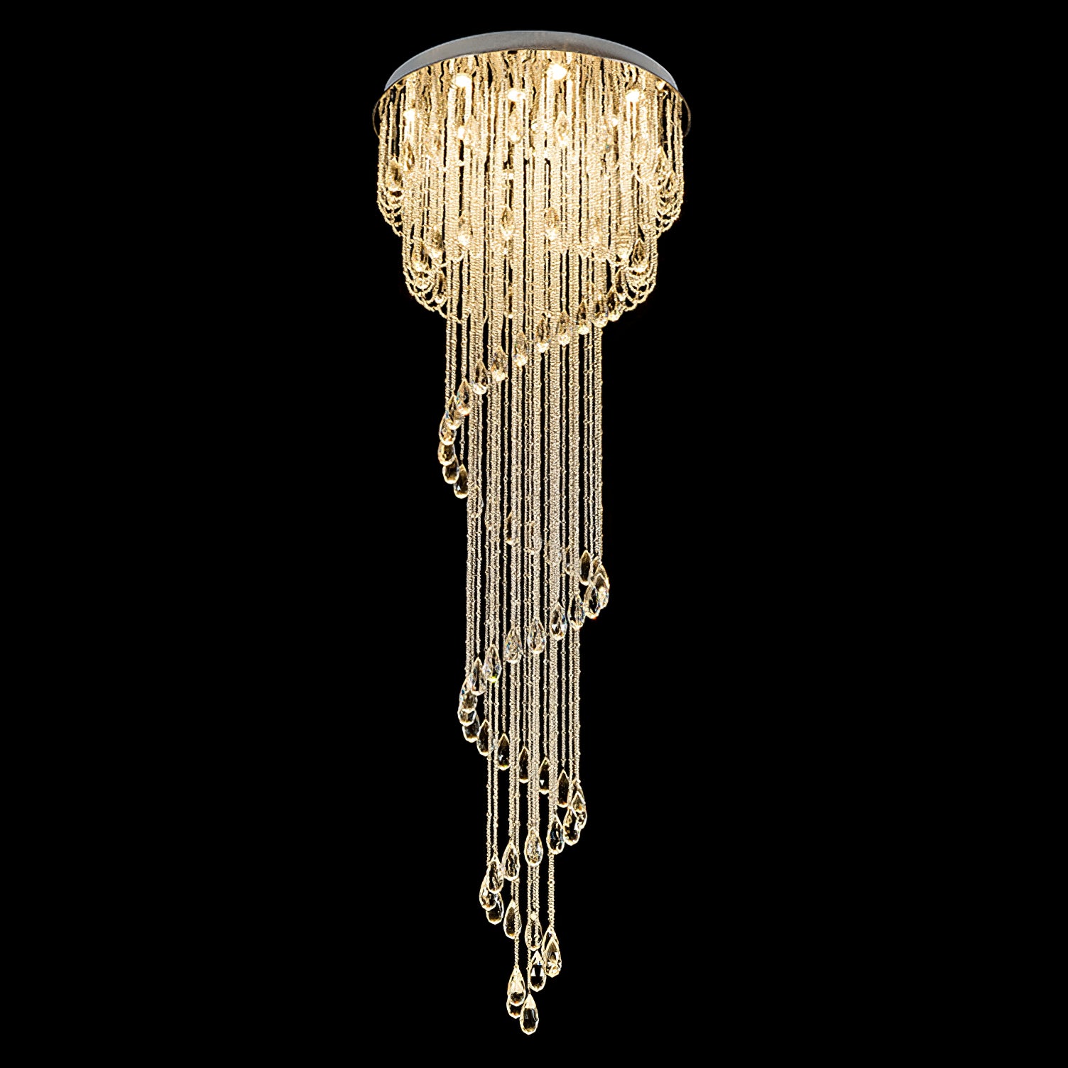 Full warm-lit crystal spiral isolated on black, with a round chrome disc, layered upper bead rows and long teardrop ends