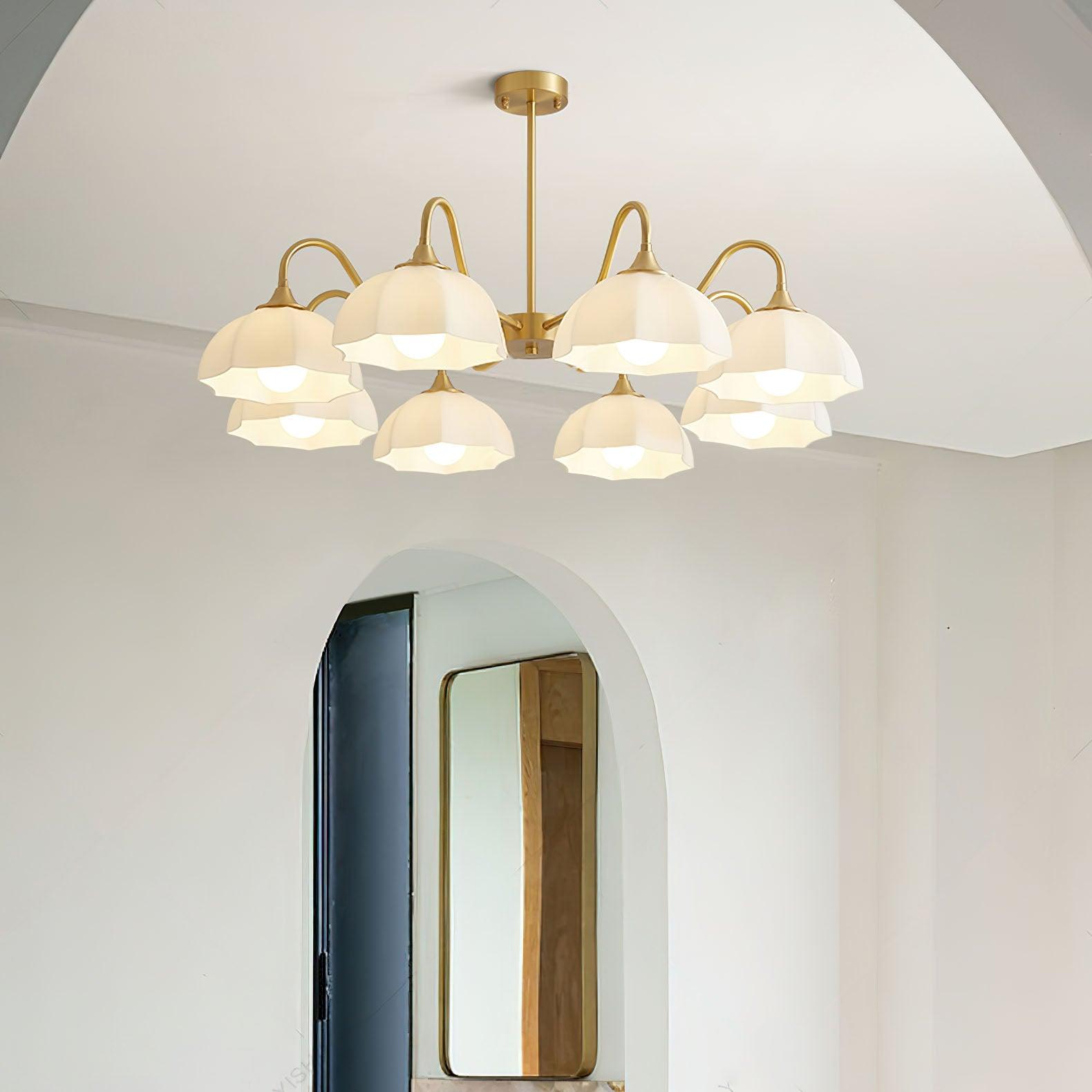 Wide chandelier with white glass bowls near an arch