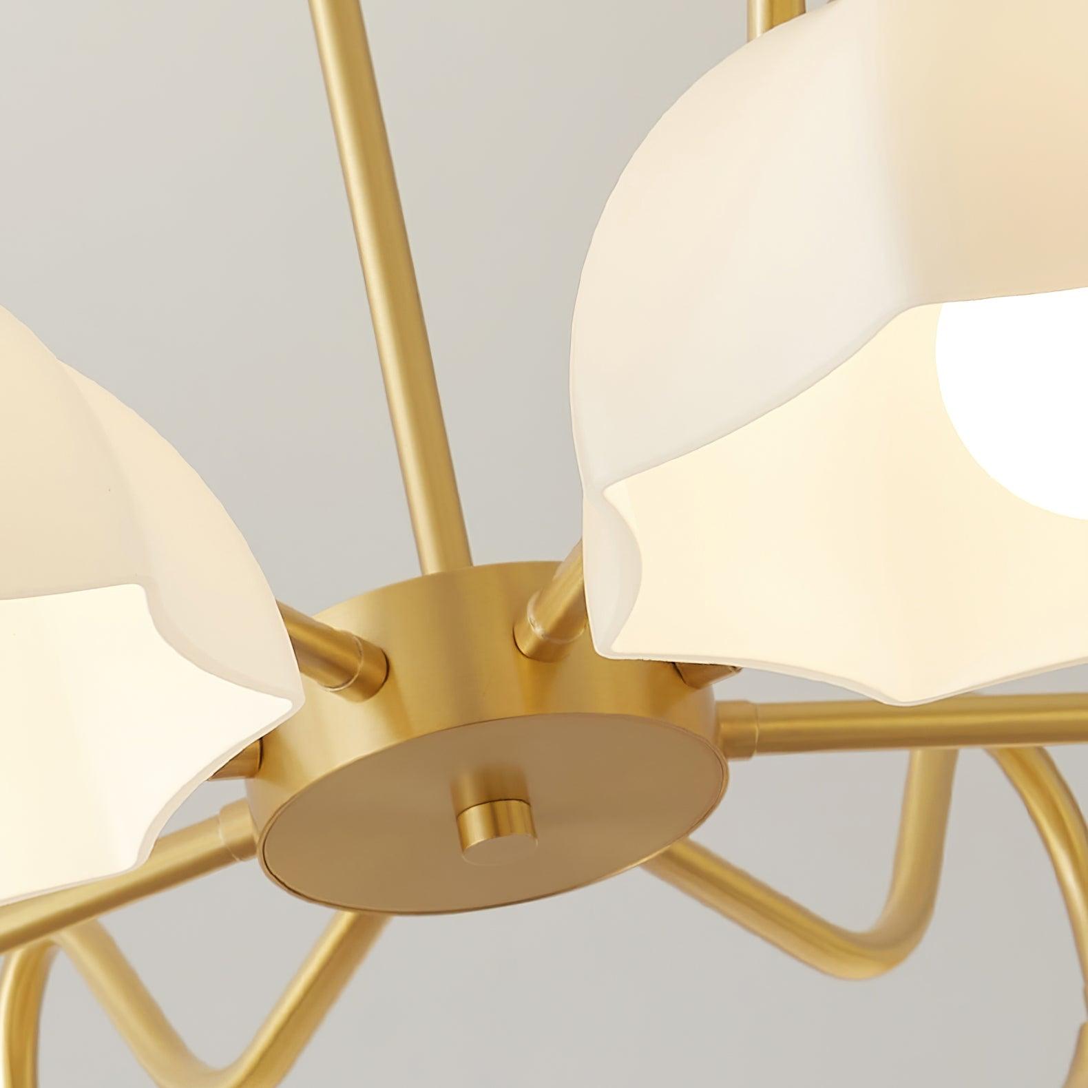 Close view of brass arms below white glass shades