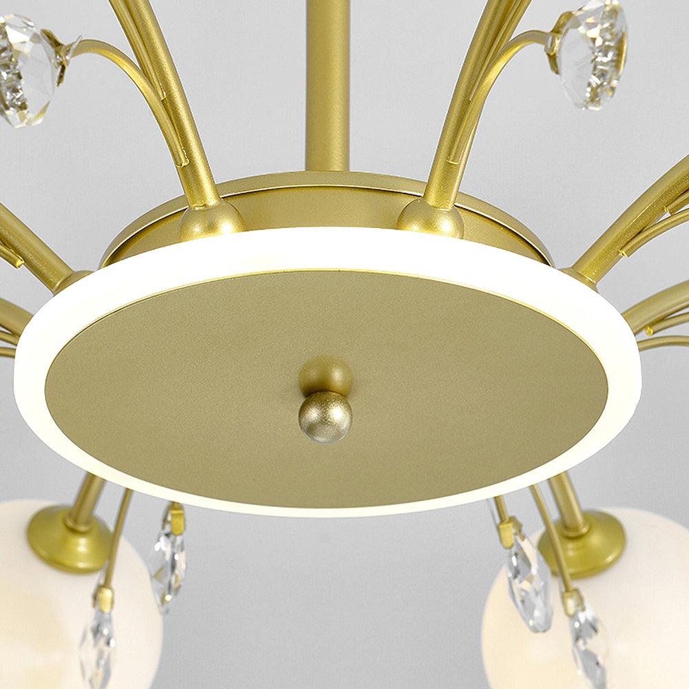 Close-up of Gold circular hub underside, bright white rim, central finial and curved arm connections, with clear drops behind