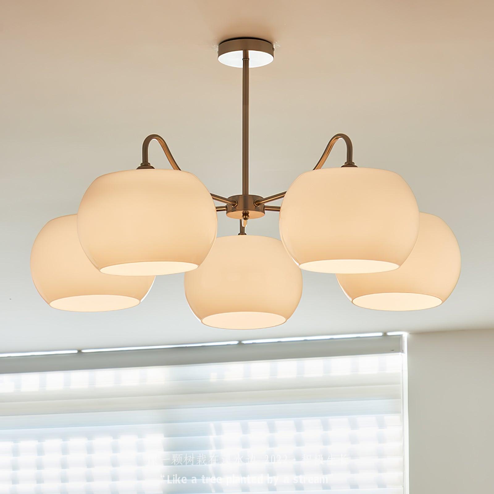 Persimmon chandelier with white glass shades and curved nickel-tone arms