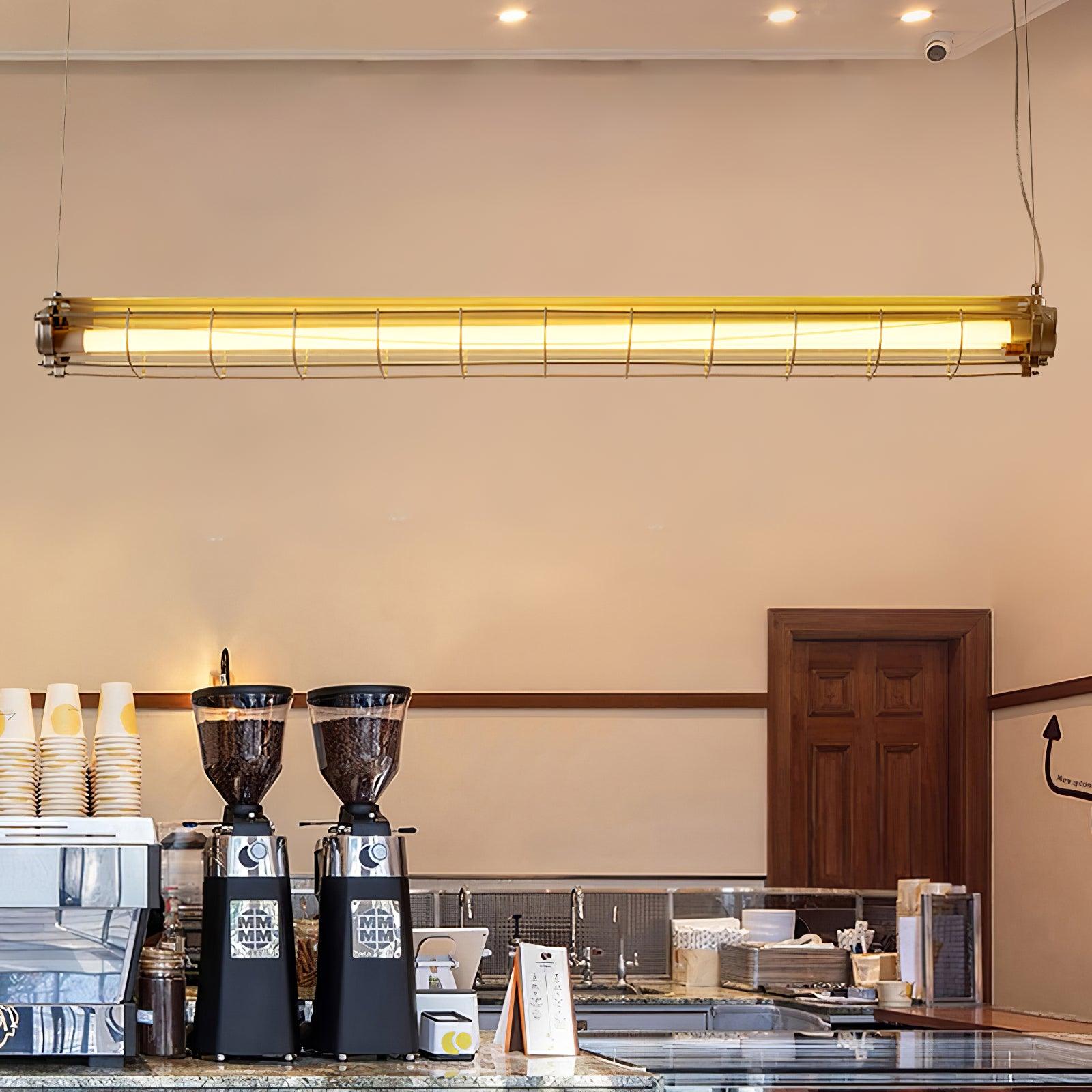 Artisan Glass linear chandelier above coffee grinders and a cafe display counter