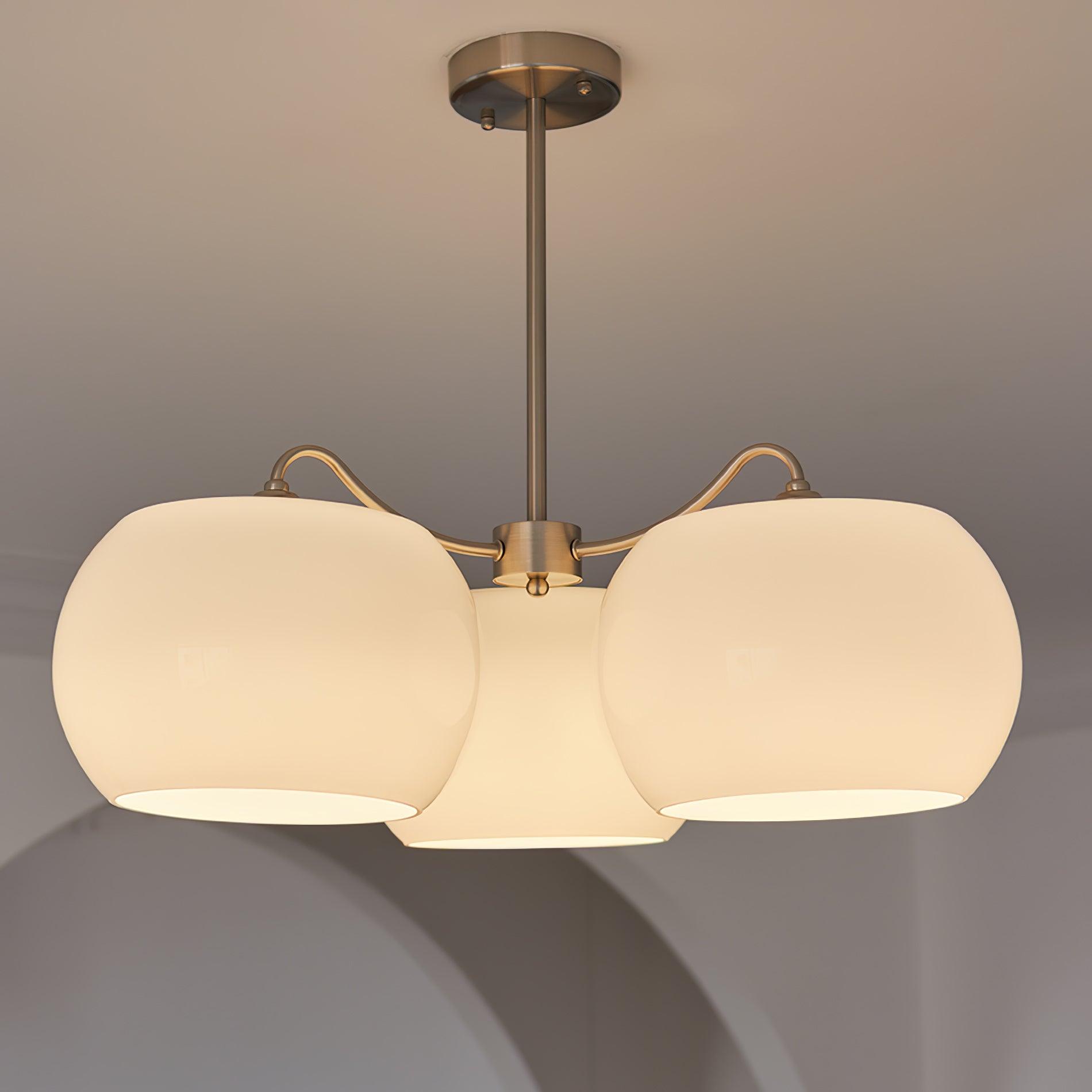 Persimmon chandelier with white glass shades and curved nickel-tone arms