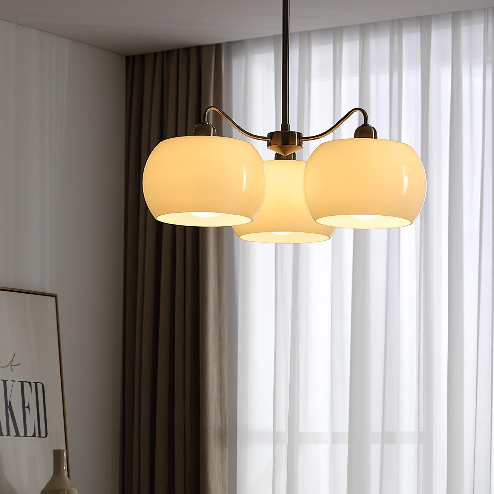 Persimmon chandelier with white glass shades and curved nickel-tone arms