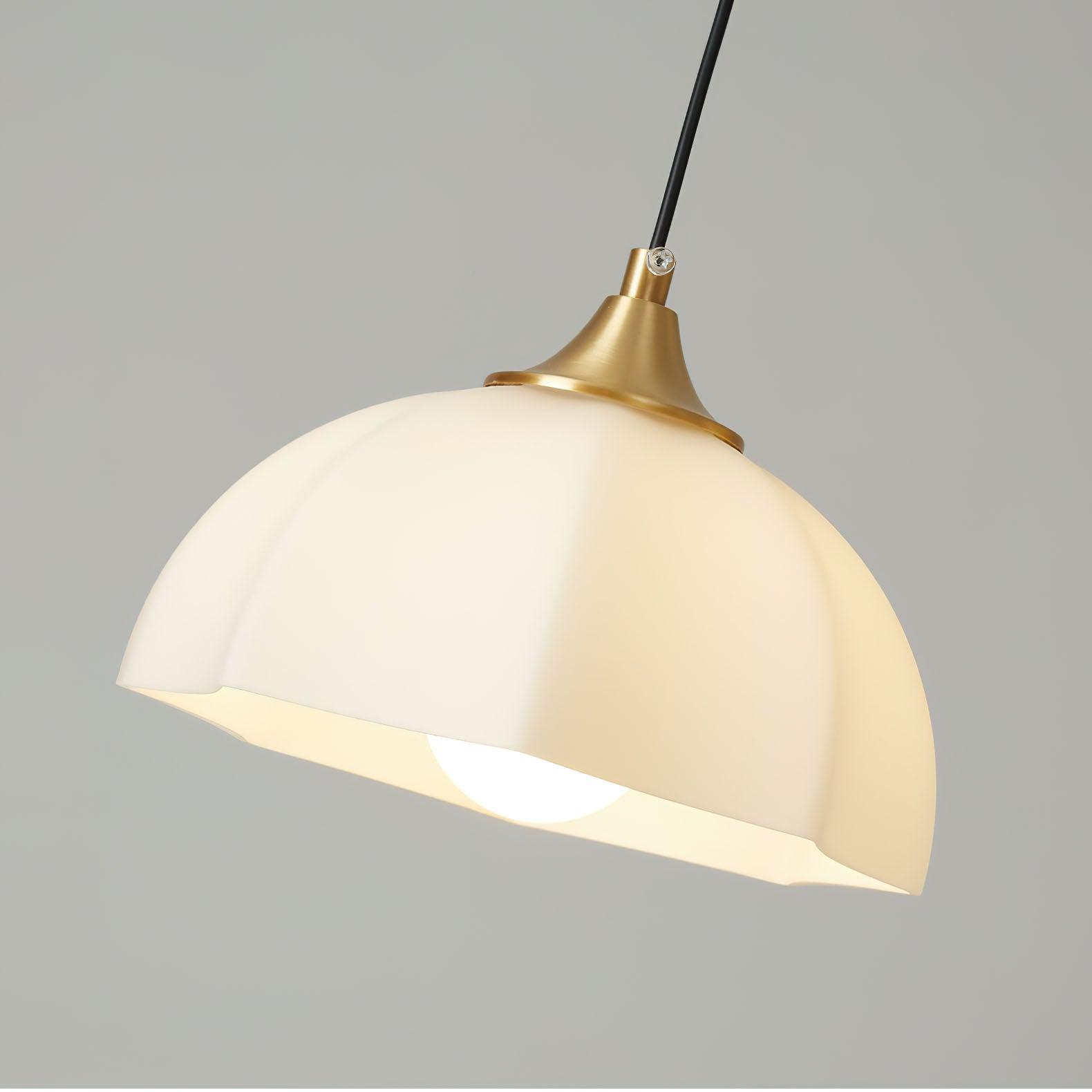 Close view of white glass hanging shade and cable