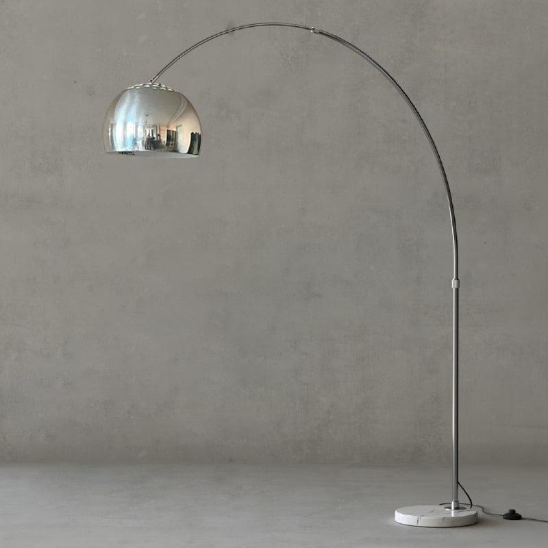 Complete reflective chrome dome arc lamp on grey backdrop with silver stem, round marble base and floor switch