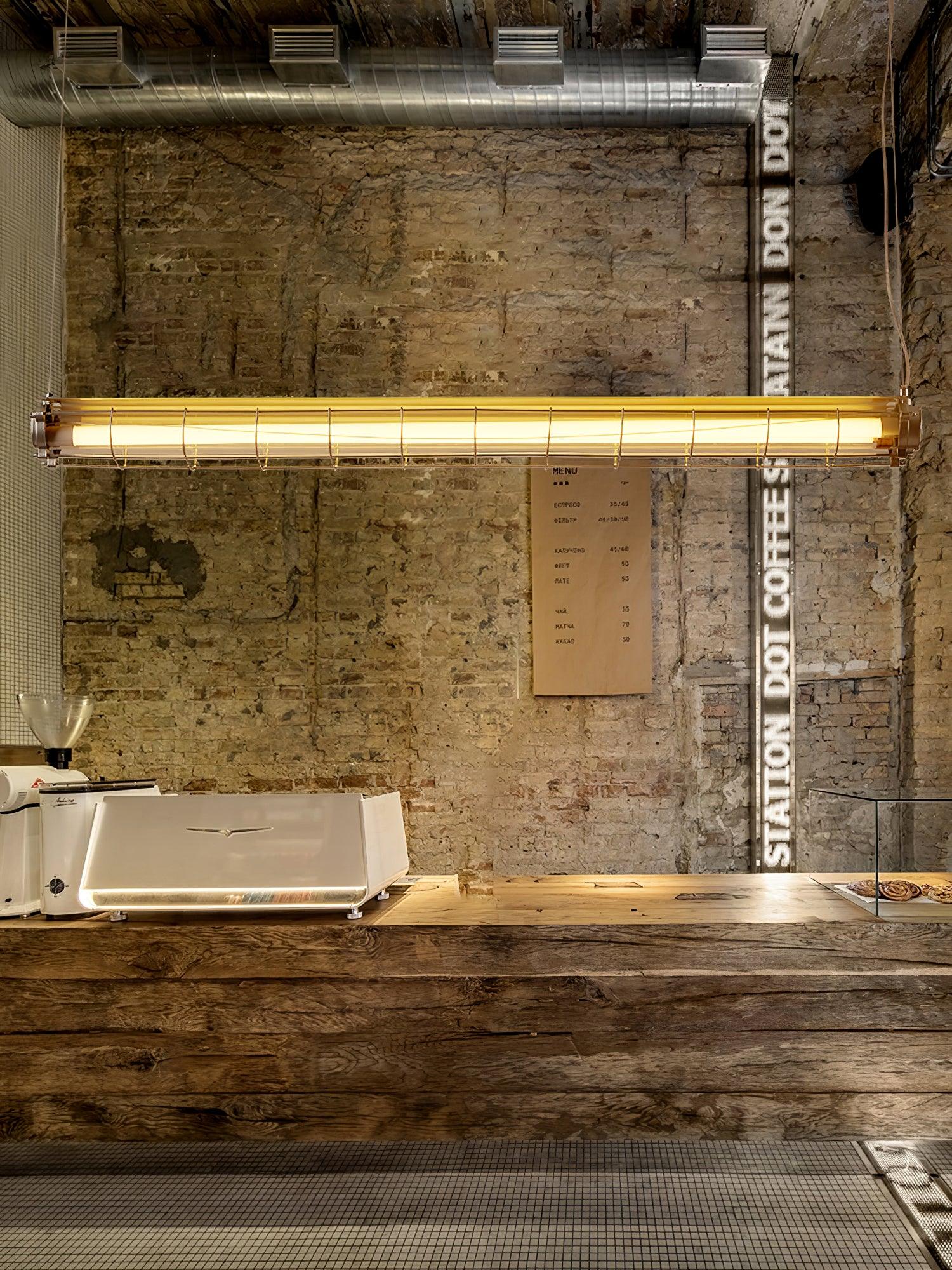 Front view of Artisan Glass lighting against a textured brick wall above a counter