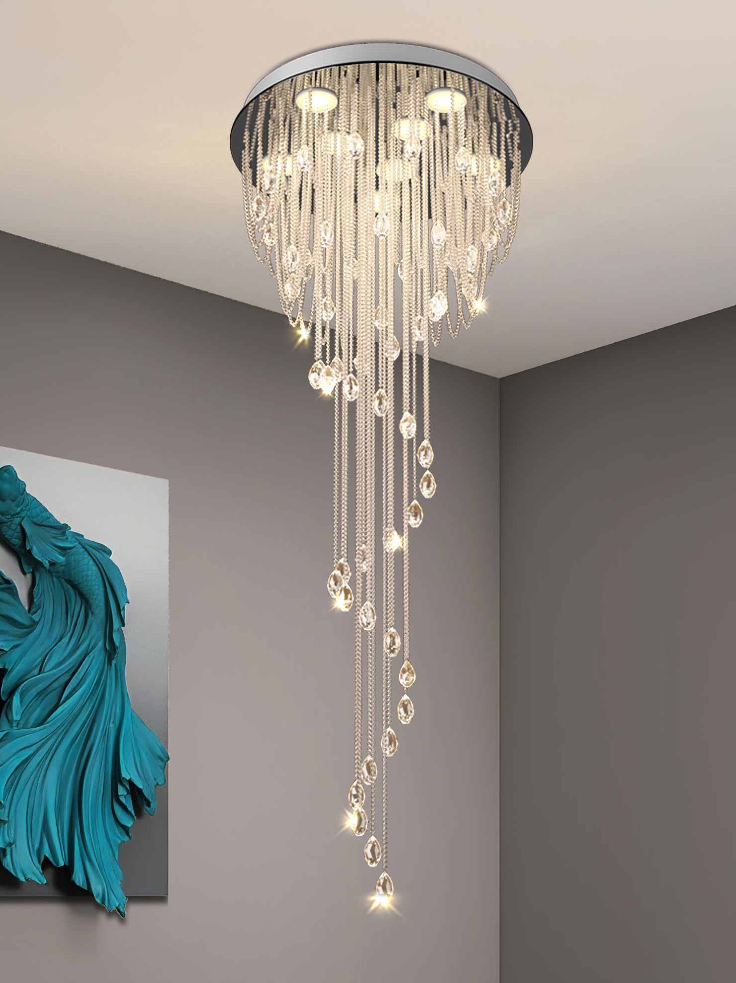 Close lit crystal spiral against gray walls, with turquoise sculptural wall artwork at left