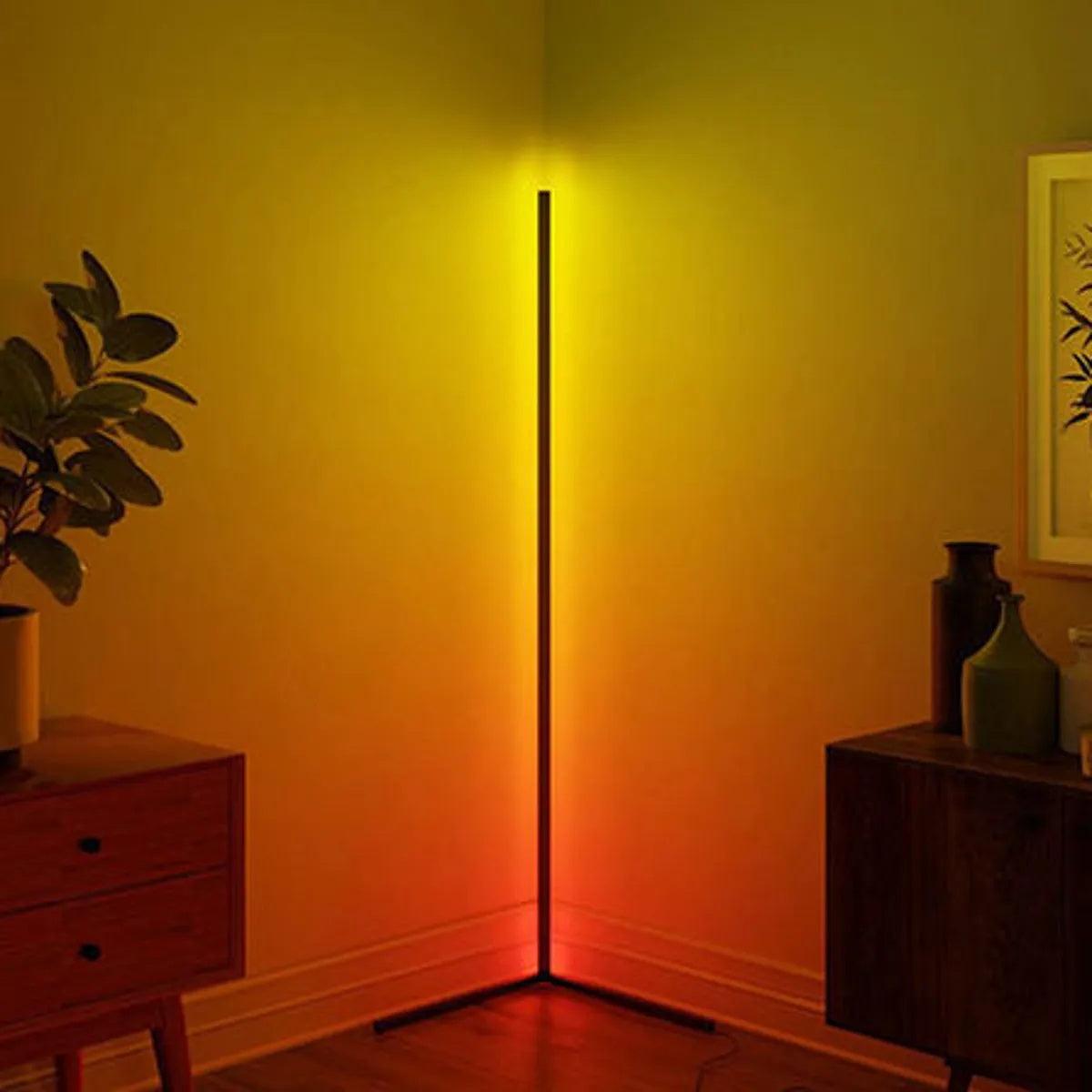 Corner floor lamp shown casting yellow, orange and red wall light between wooden storage units