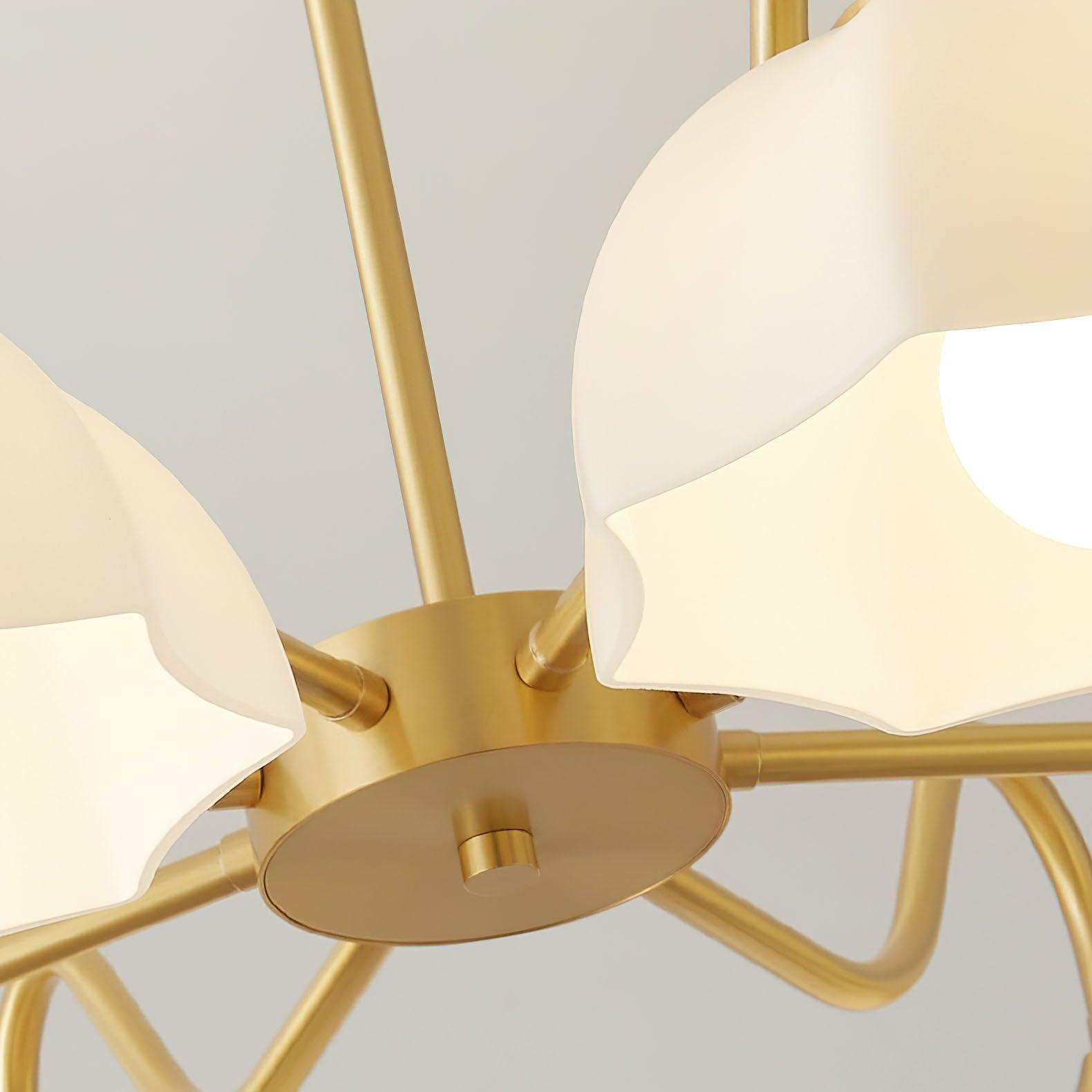Close view of curved brass chandelier arms and centre hub