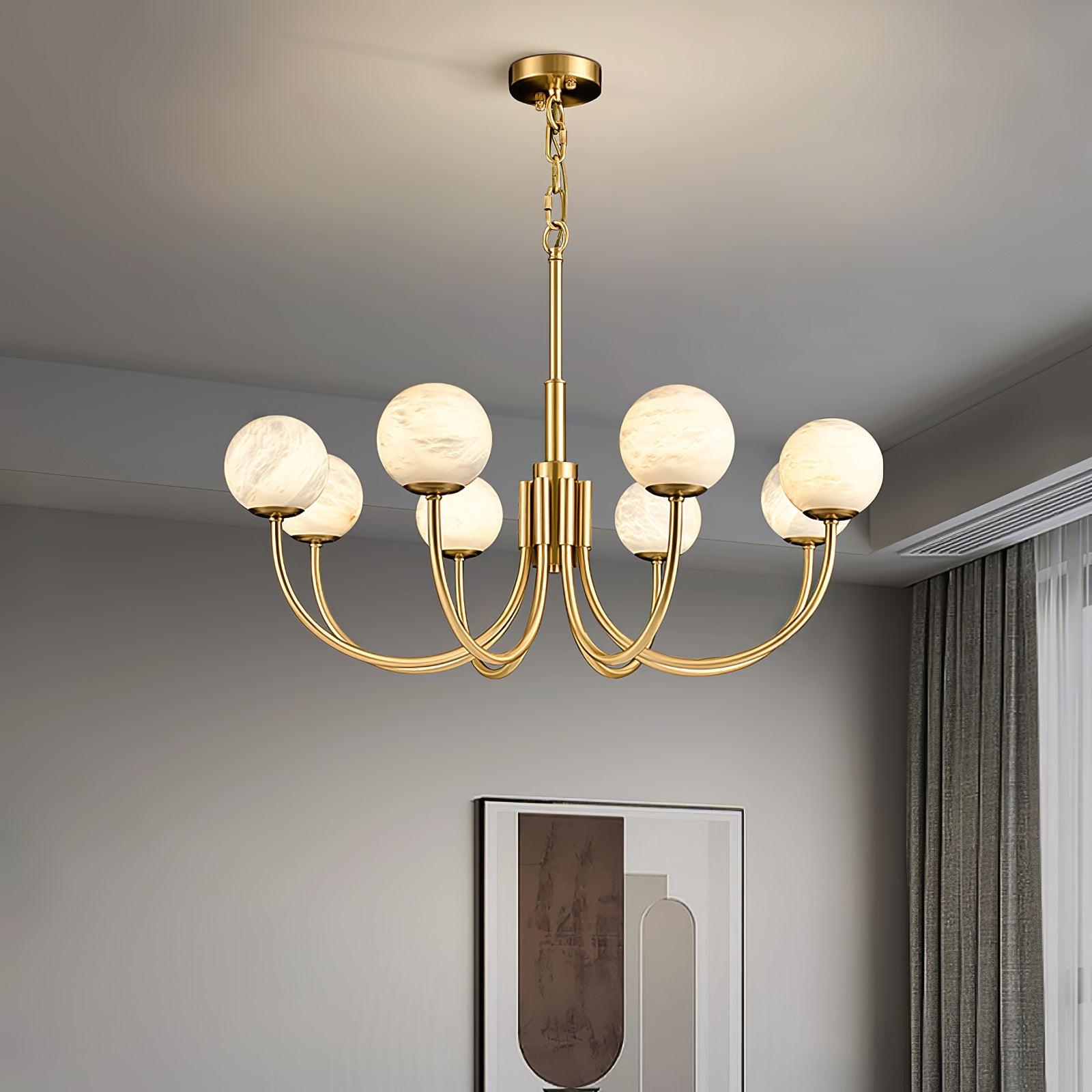 White globe chandelier above grey sofa