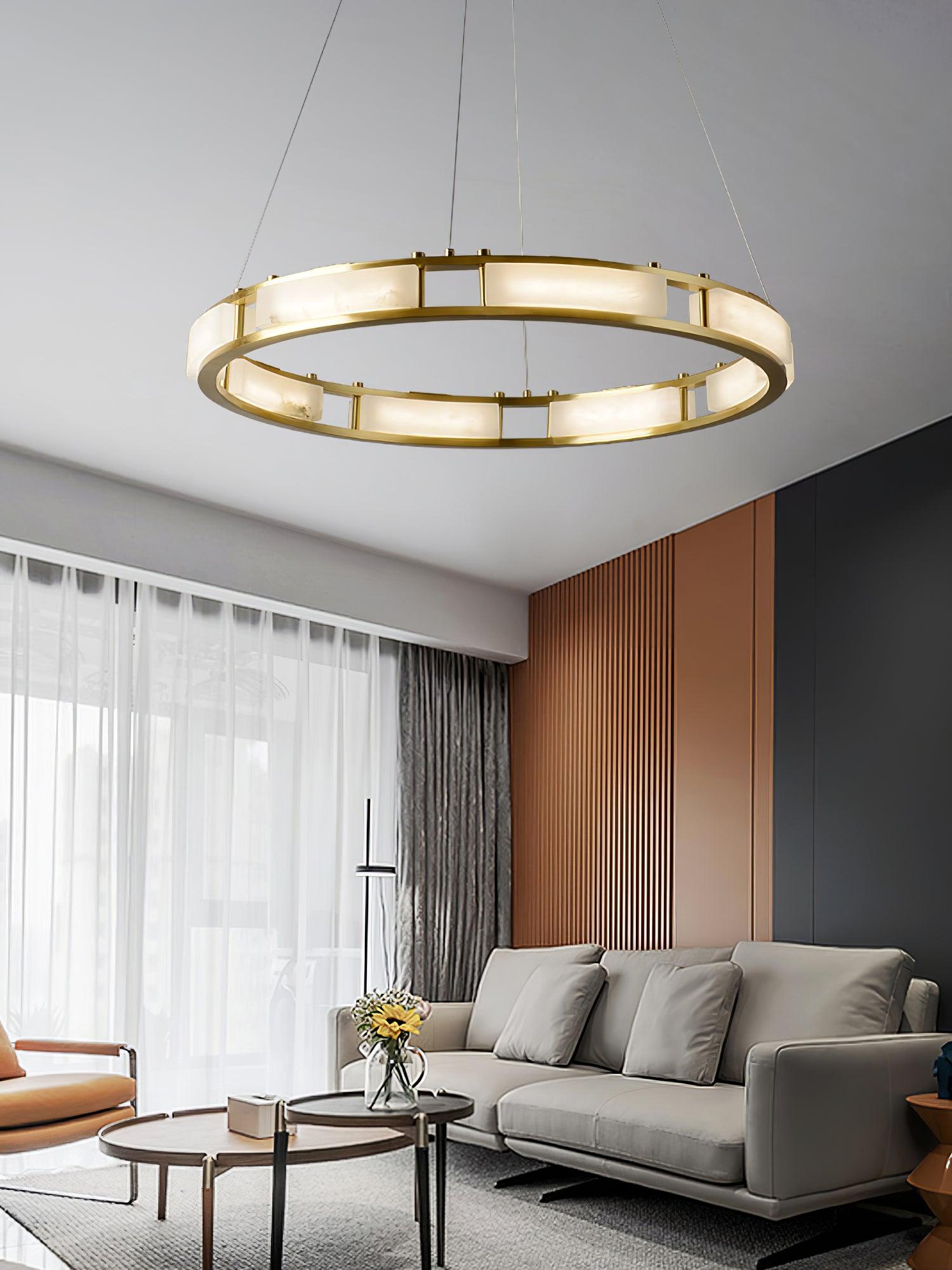 Qatar brass ring chandelier beside curtains and a grey sofa