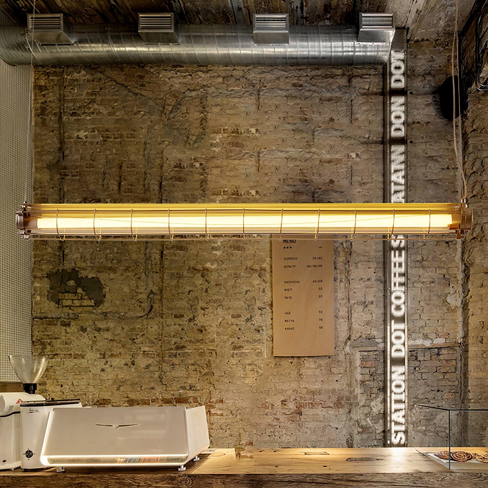 Artisan Glass chandelier hanging against an exposed brick wall above a counter