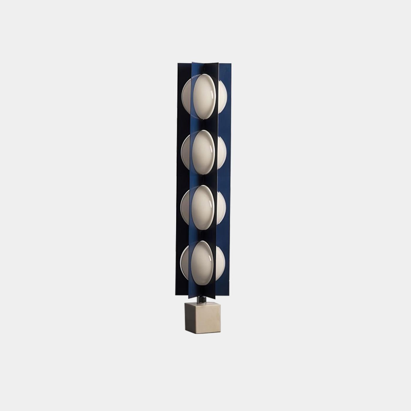 Wide isolated view of the unlit four-level blue column lamp and white marble block base