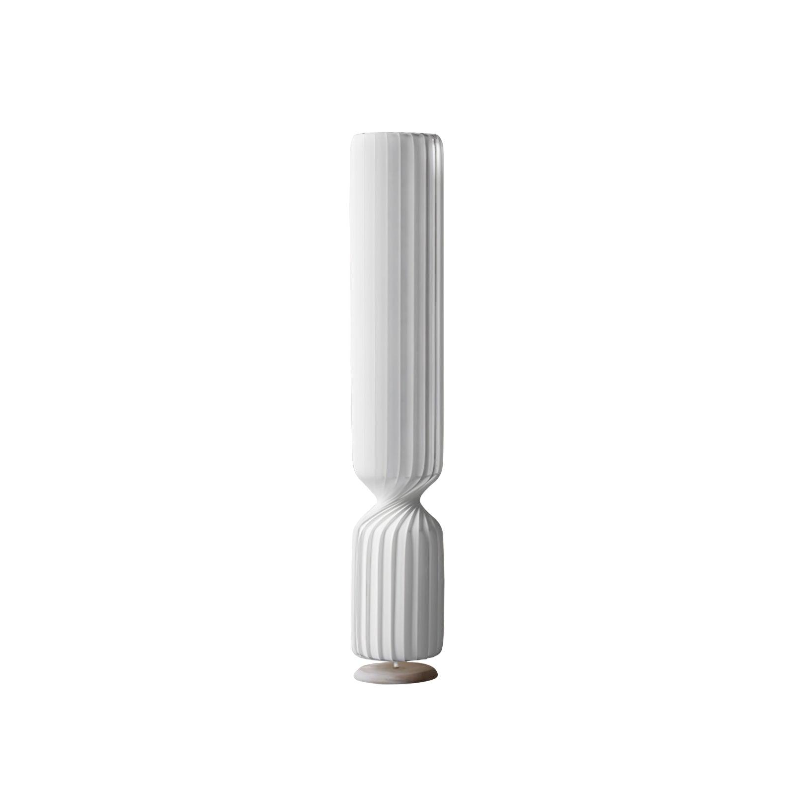 Tall white Twist lamp isolated on white, with unlit-looking pleated column, narrow twisting waist and pale round base