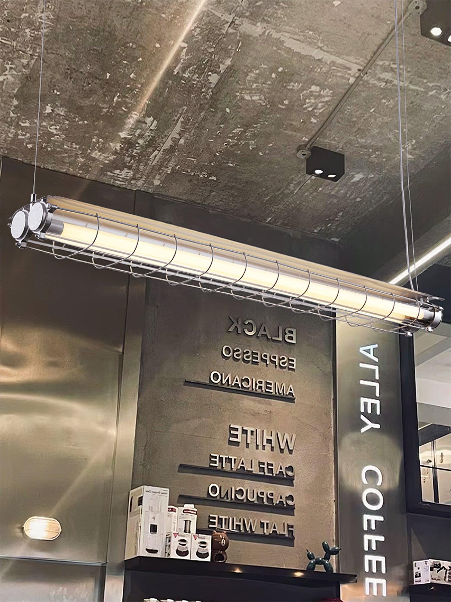 Upward angled view of an Artisan Glass chandelier beneath a concrete ceiling