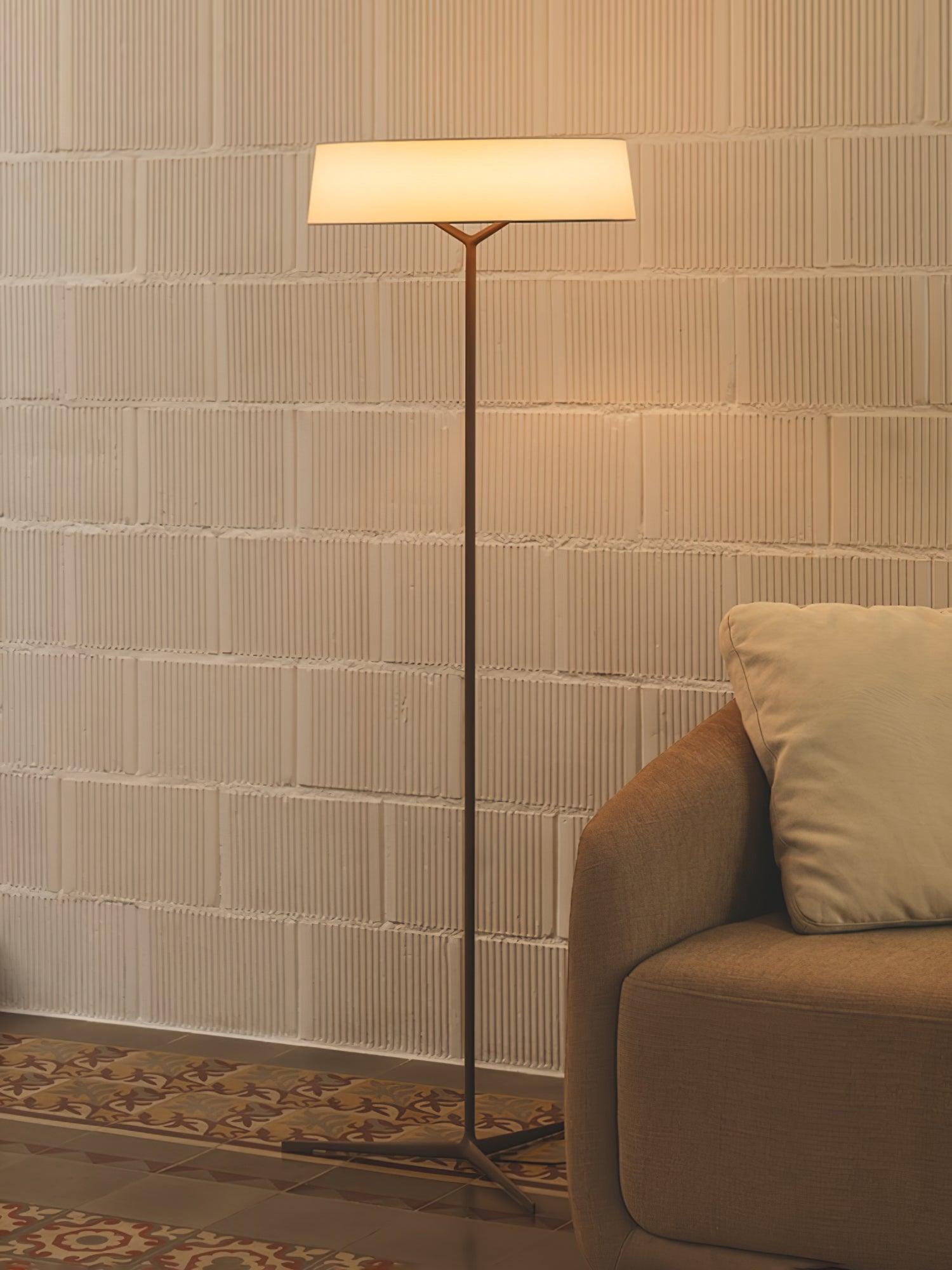 Circular floor lamp in a stone-wall seating area