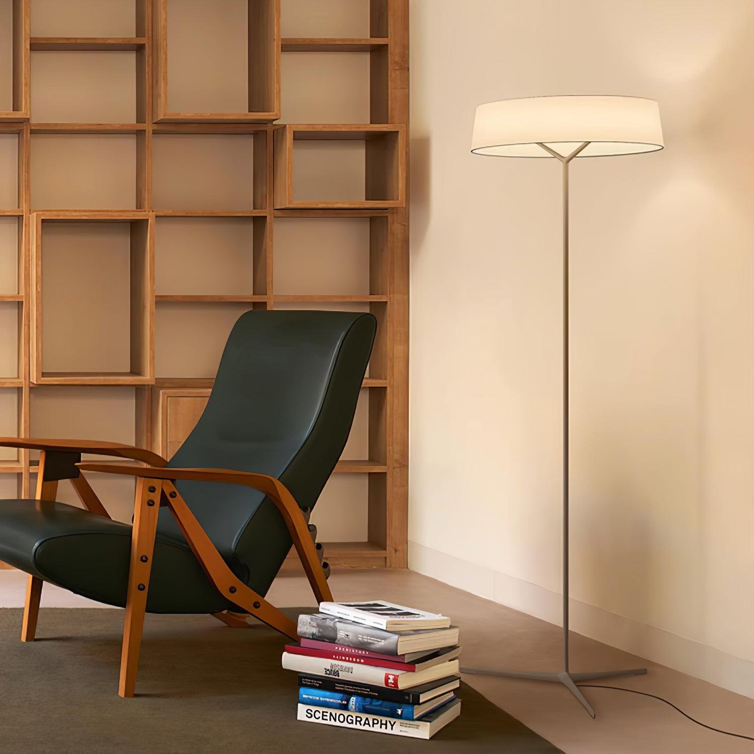 Paper Glow floor lamp beside a lounge chair and shelves