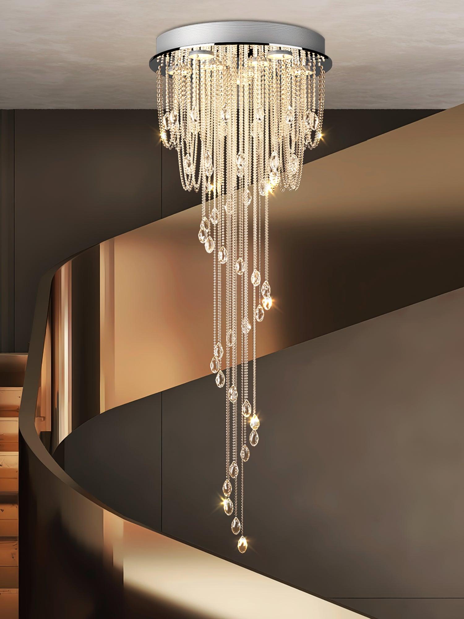 Warm-lit crystal spiral with round silver canopy before a dark curved stair enclosure and glass balustrade