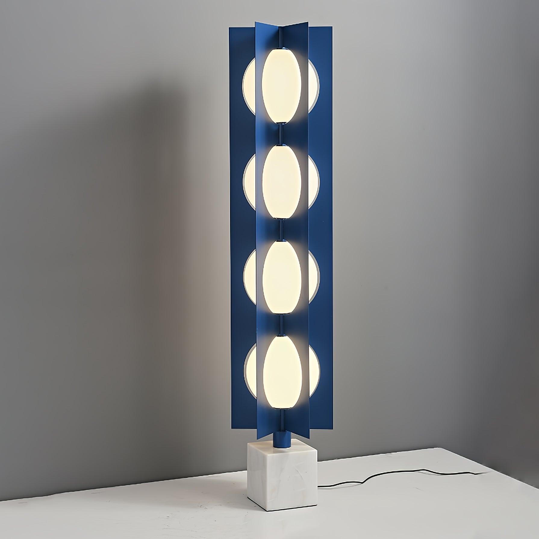 Lit four-level Cascade Tower on a pale surface with blue fins, a white marble base and black lead
